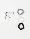 Cozy Earth Bamboo Stretch Knit Skinny Scrunchies in Grey, Ivory, and Black pictured with storage bag on a white background. |Color:Black/Ivory/Light Grey