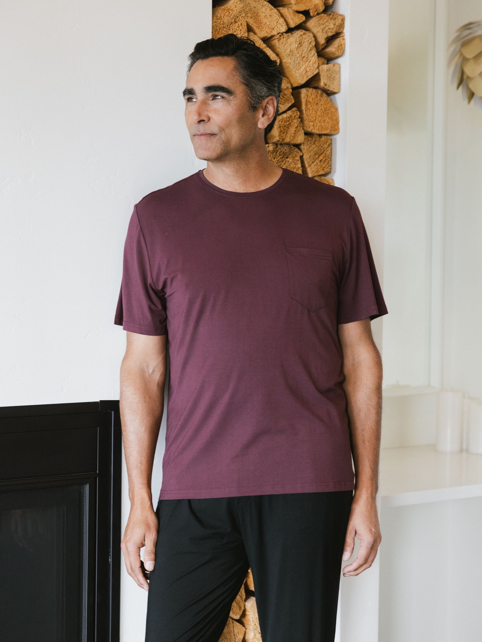 Burgundy Men's Stretch-Knit Bamboo Lounge Tee. A man is wearing the lounge tee in a well lit home.