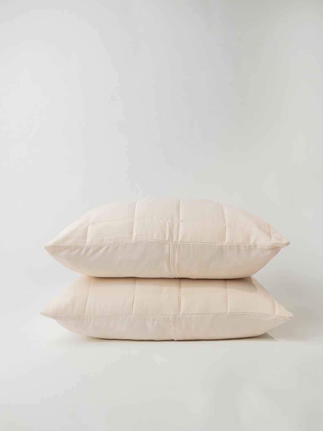 Buttermilk Aire Bamboo Box Quilt Euro Sham standard size. The sham is resting on a white background