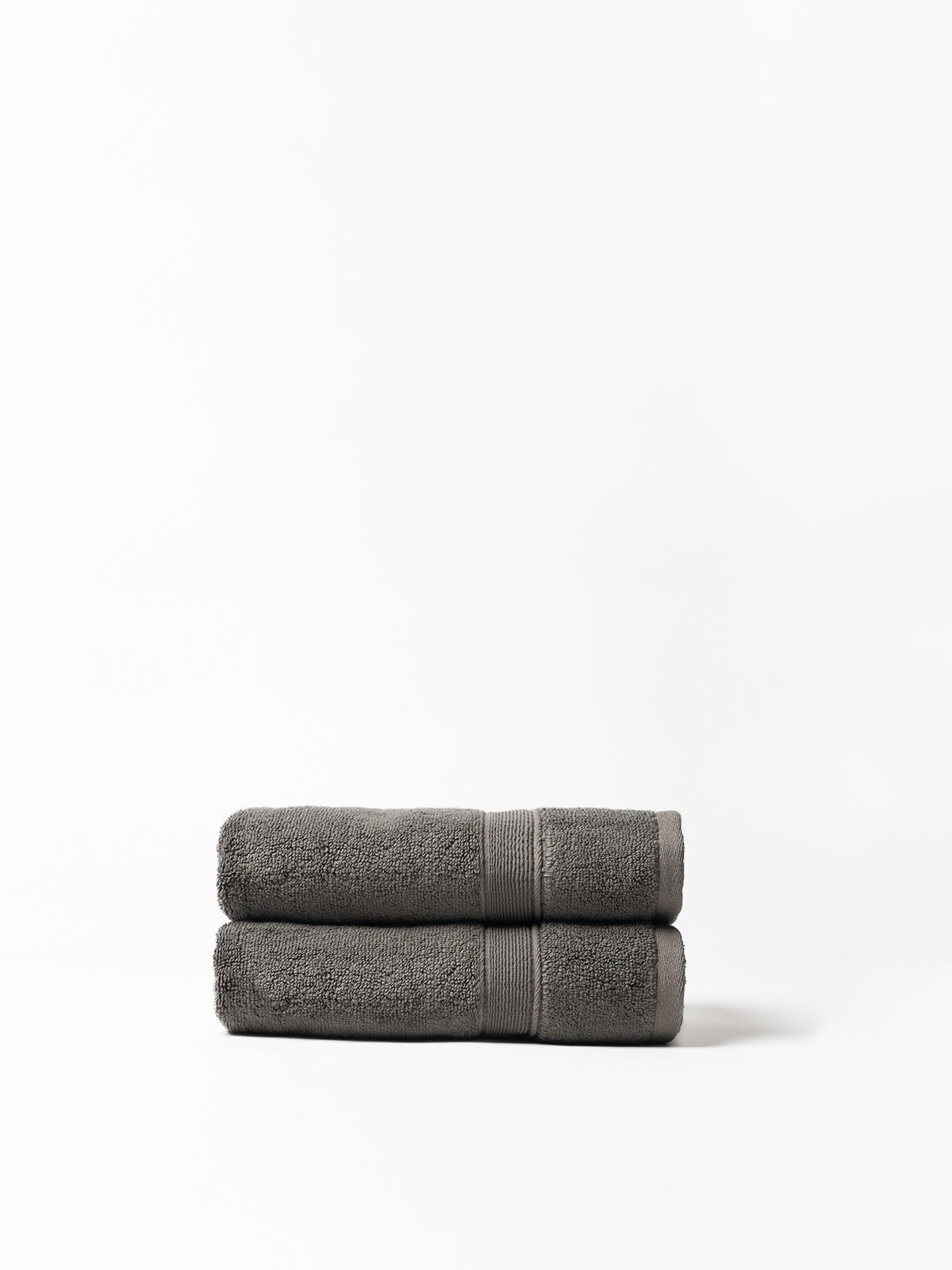 Charcoal luxe bath towels folded with white background 