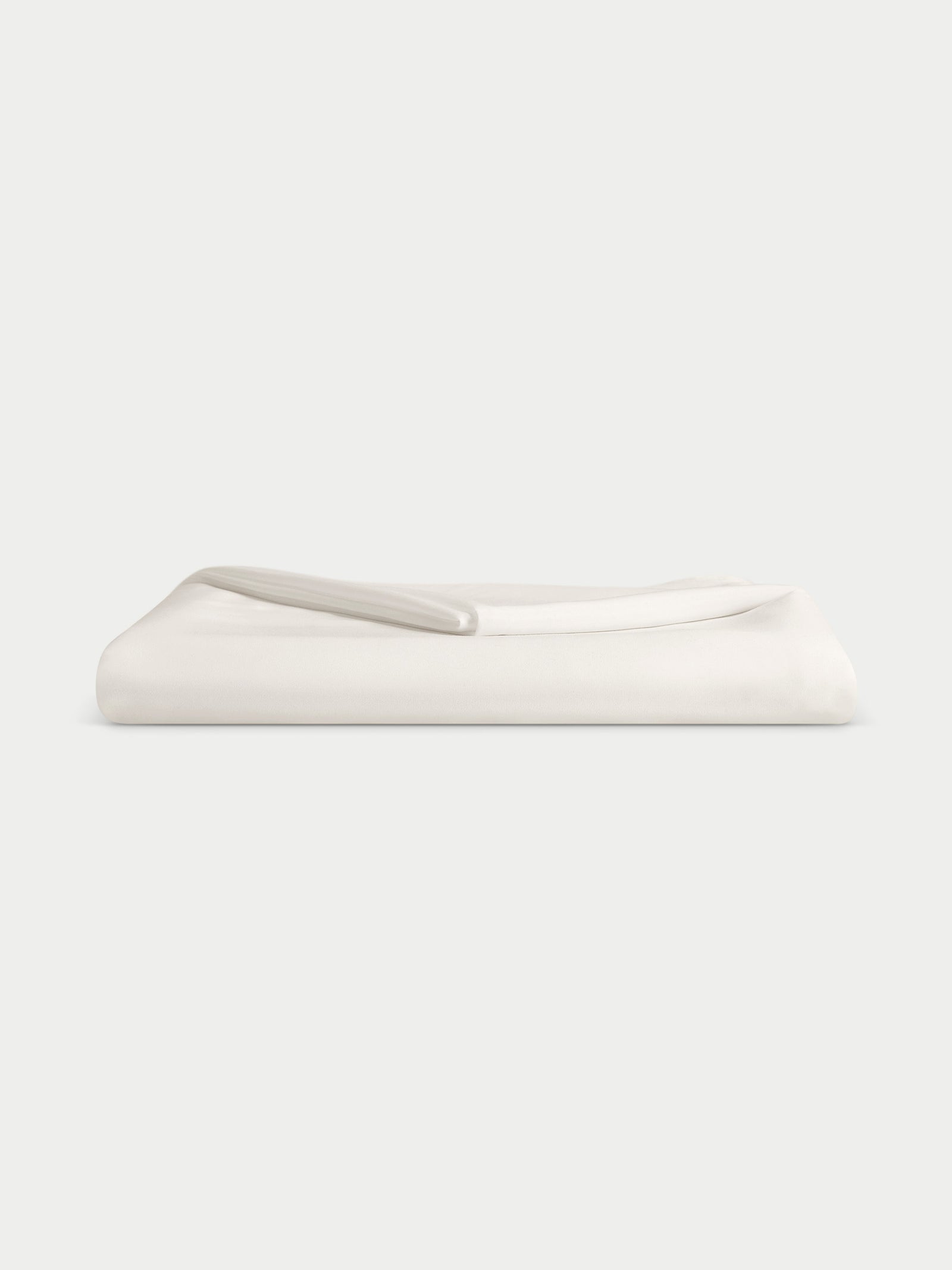 Creme top sheet folded with white background