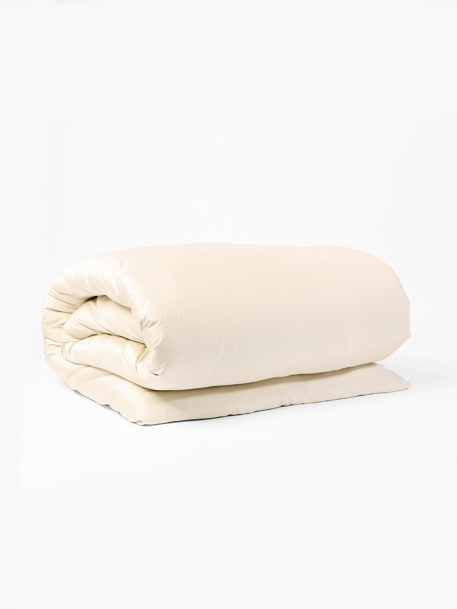 A neatly folded Bamboo Duvet Cover by Cozy Earth lies against a plain white background. The cream-colored duvet showcases its soft and smooth texture, suggesting it is plush and comfortable. The duvet appears clean and well-maintained, ready for use.
