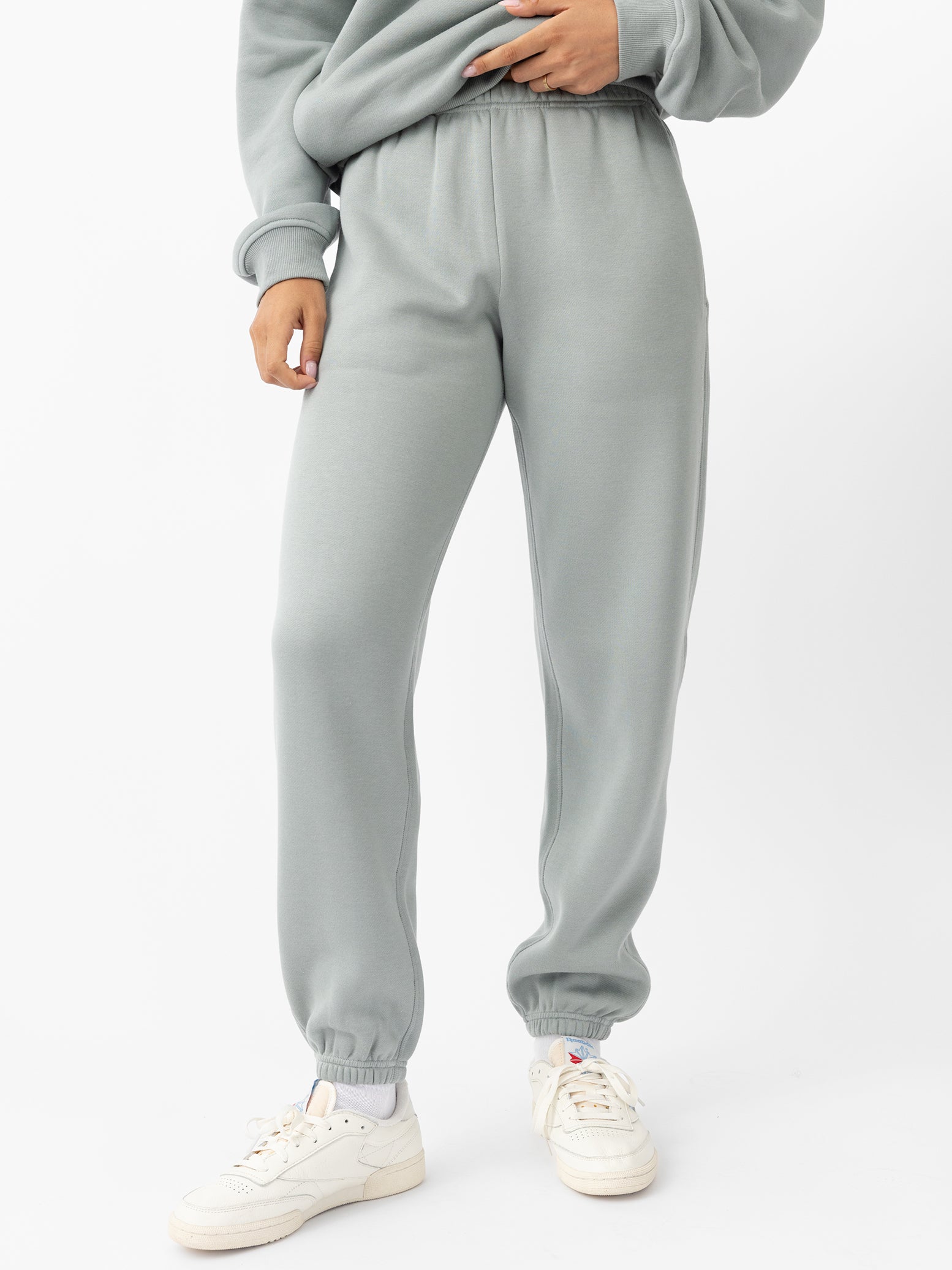 Haze CityScape Joggers. The Joggers are being worn by a female model. The photo is taken with the models hand by the pocket of the joggers. The back ground is a crisp white background. 