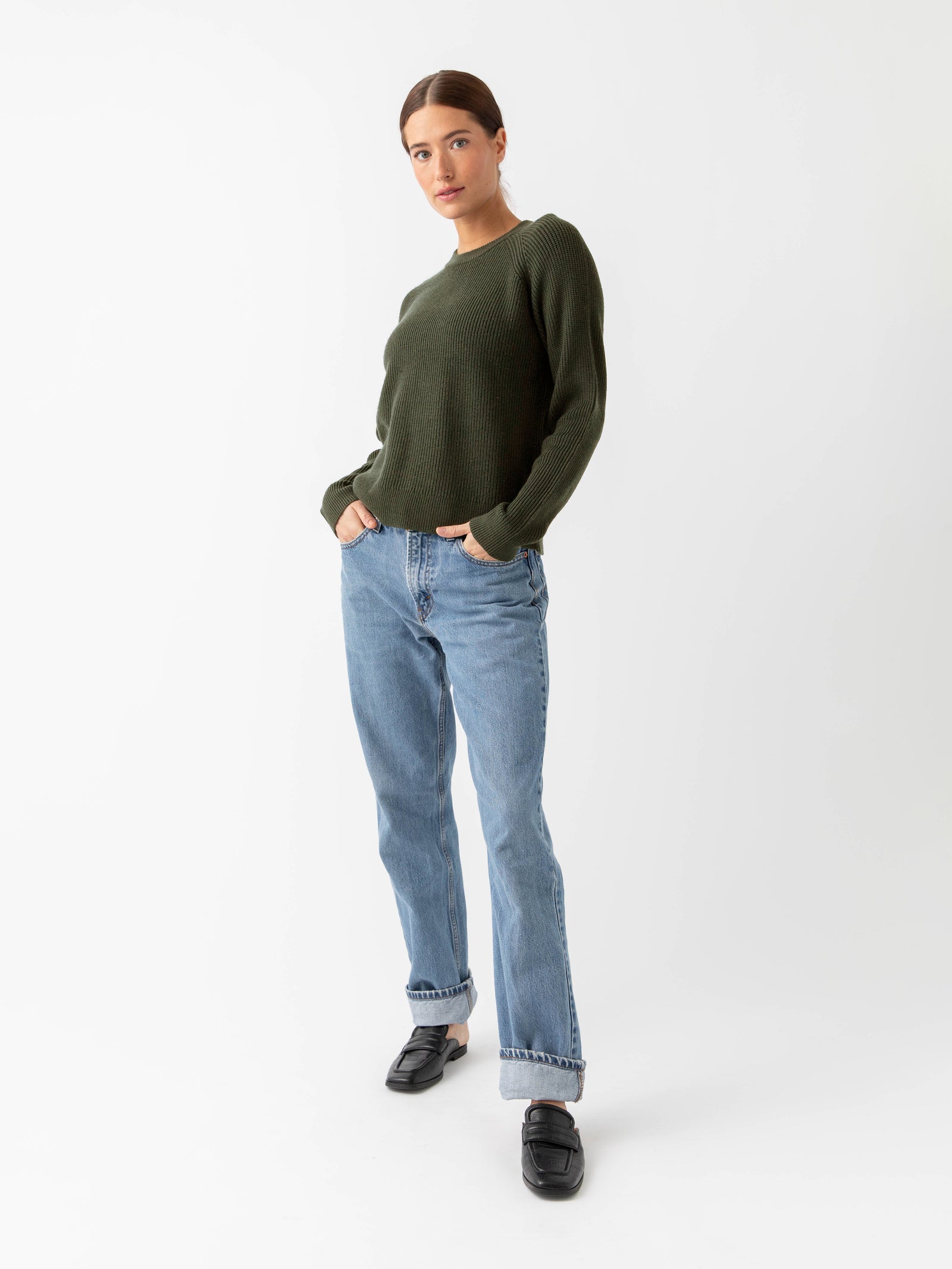 Woman wearing juniper classic crewneck and jeans with white background