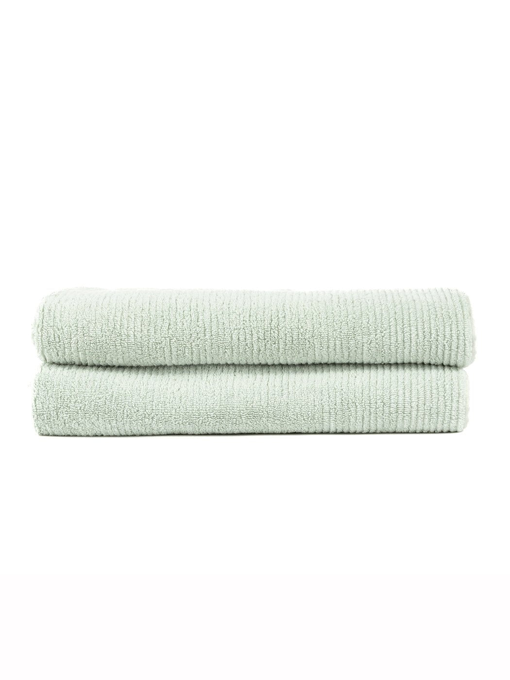 Two Ribbed Terry Bath Sheets by Cozy Earth, neatly folded in light green, are stacked together against a plain white background.|Color:Laurel