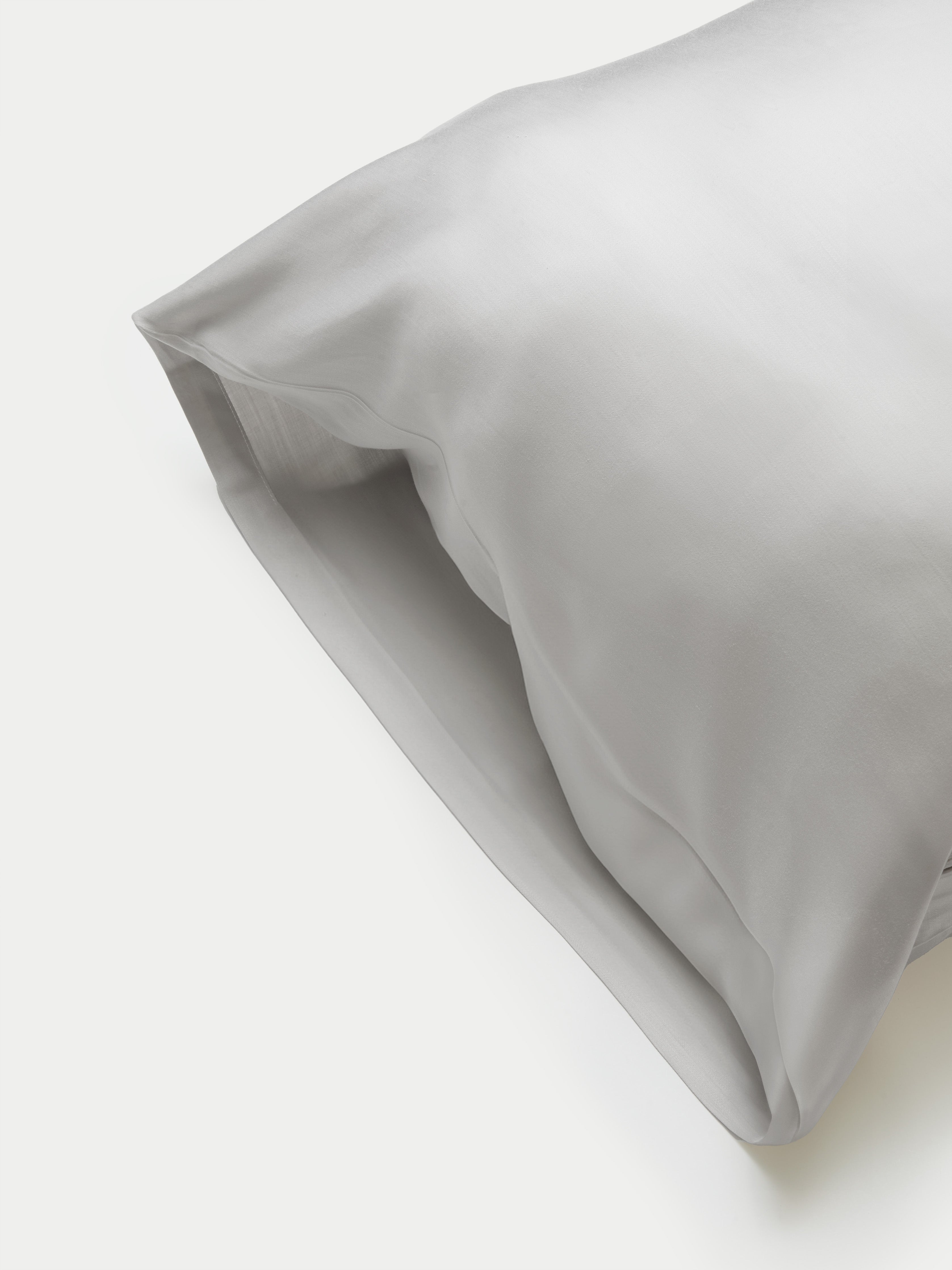 Side of light grey body pillowcase with plain background