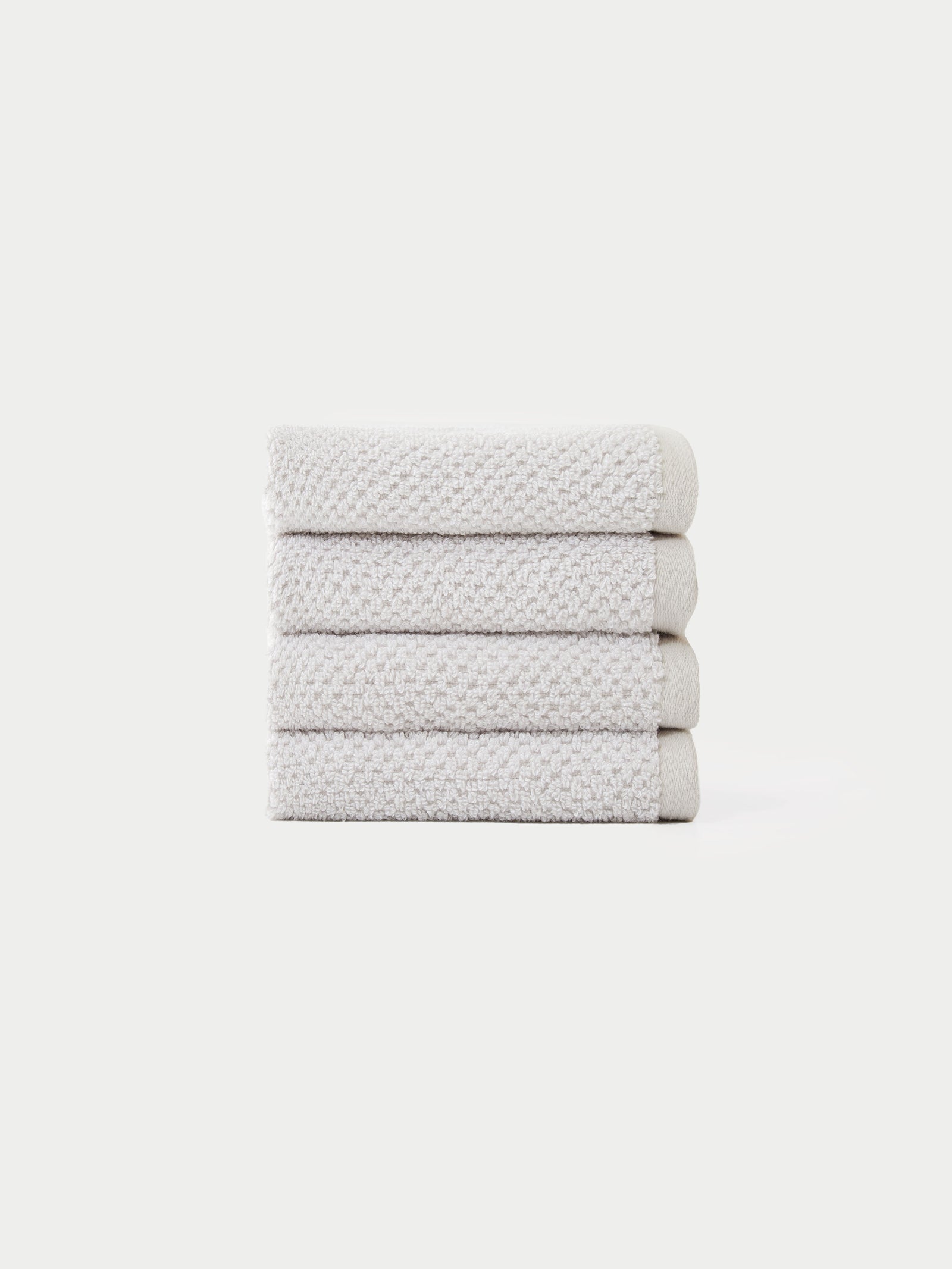Nantucket Wash Cloths in the color Heathered Light Grey. The Wash Cloths are neatly folded. The photo of the wash cloths was taken with a white background.