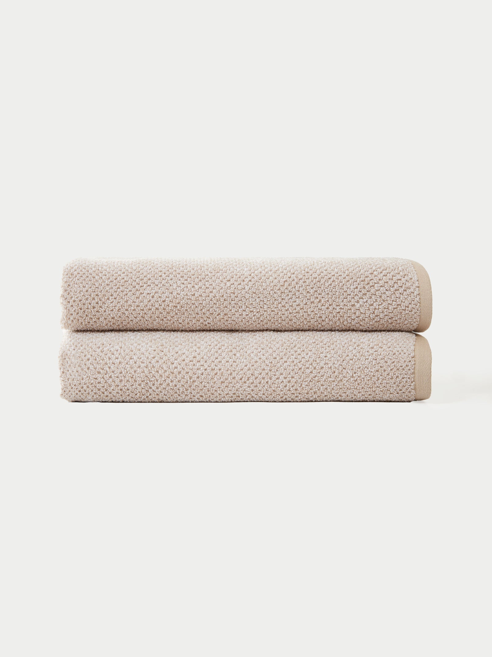 Two neatly folded towels from the Cozy Earth Complete Nantucket Bath Bundle are stacked against a plain white background.