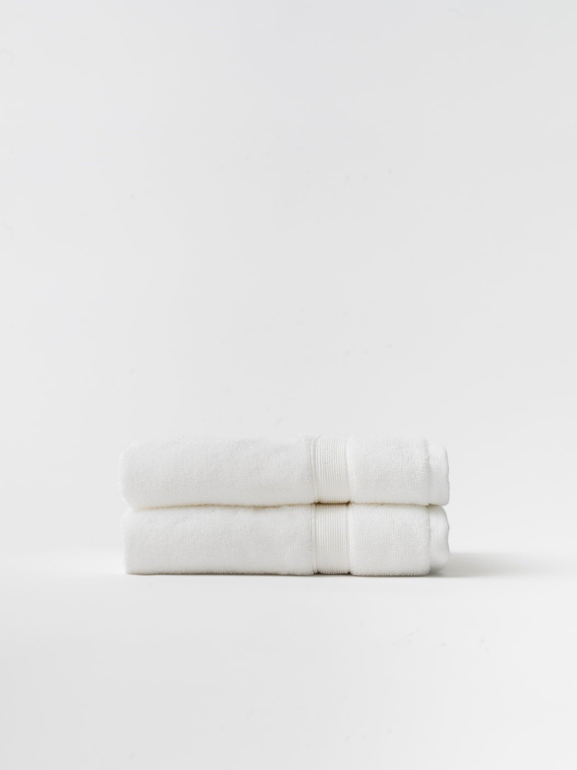 White hand towels folded with white background 