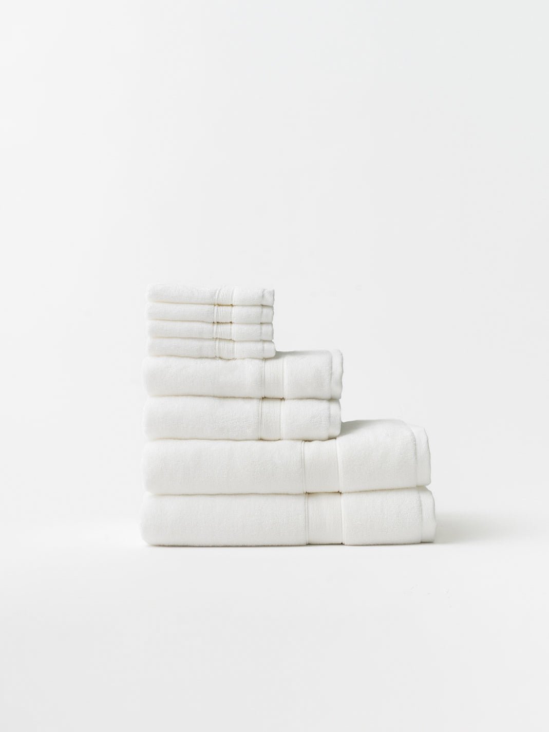 White luxe bath towel set folded with white background 