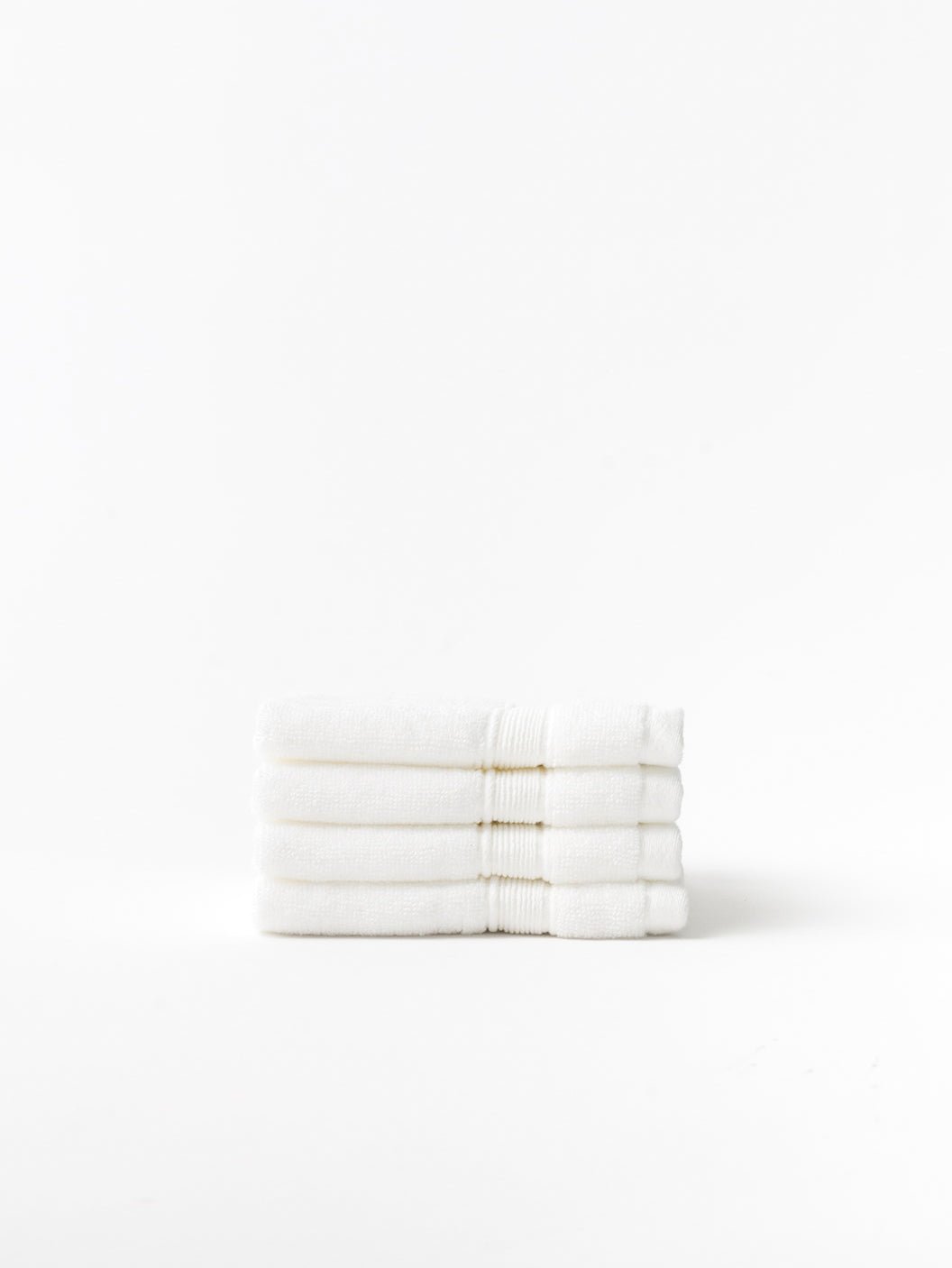 White luxe washcloths folded with white background 