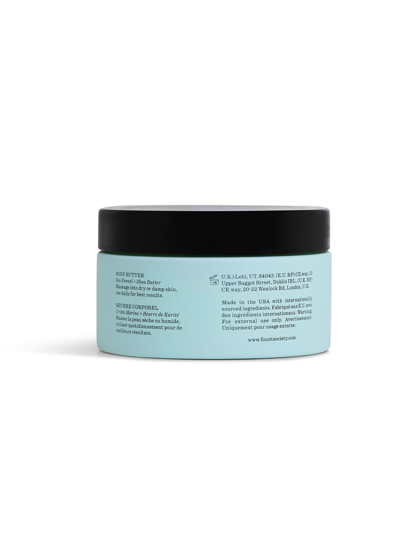 A light blue Cozy Earth Body Butter jar with a black lid is shown from the back, displaying an English and French label with product description, ingredients, directions, and company details.