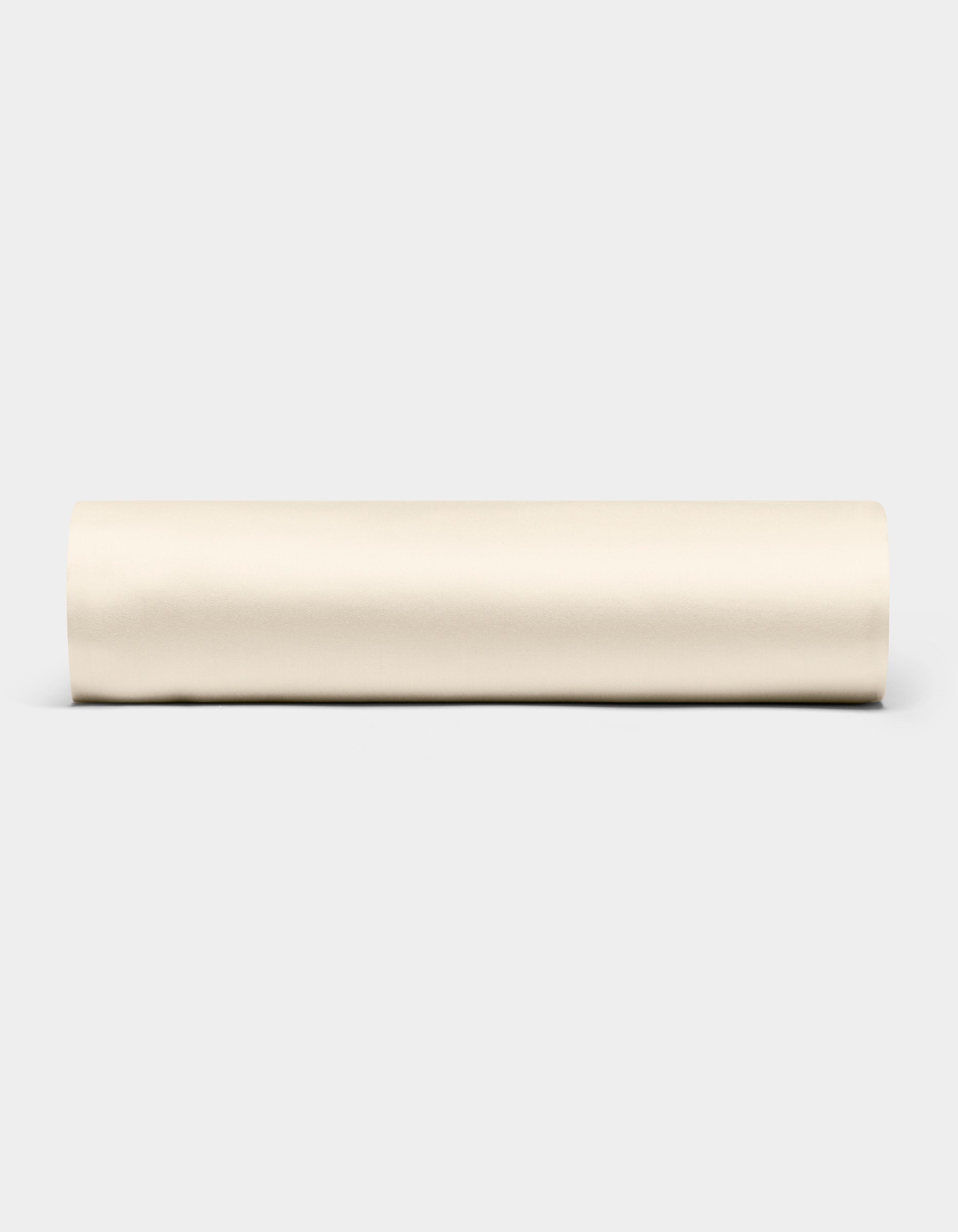 A Bamboo Fitted Sheet by Cozy Earth is displayed horizontally against a plain light gray background.|Color:Creme