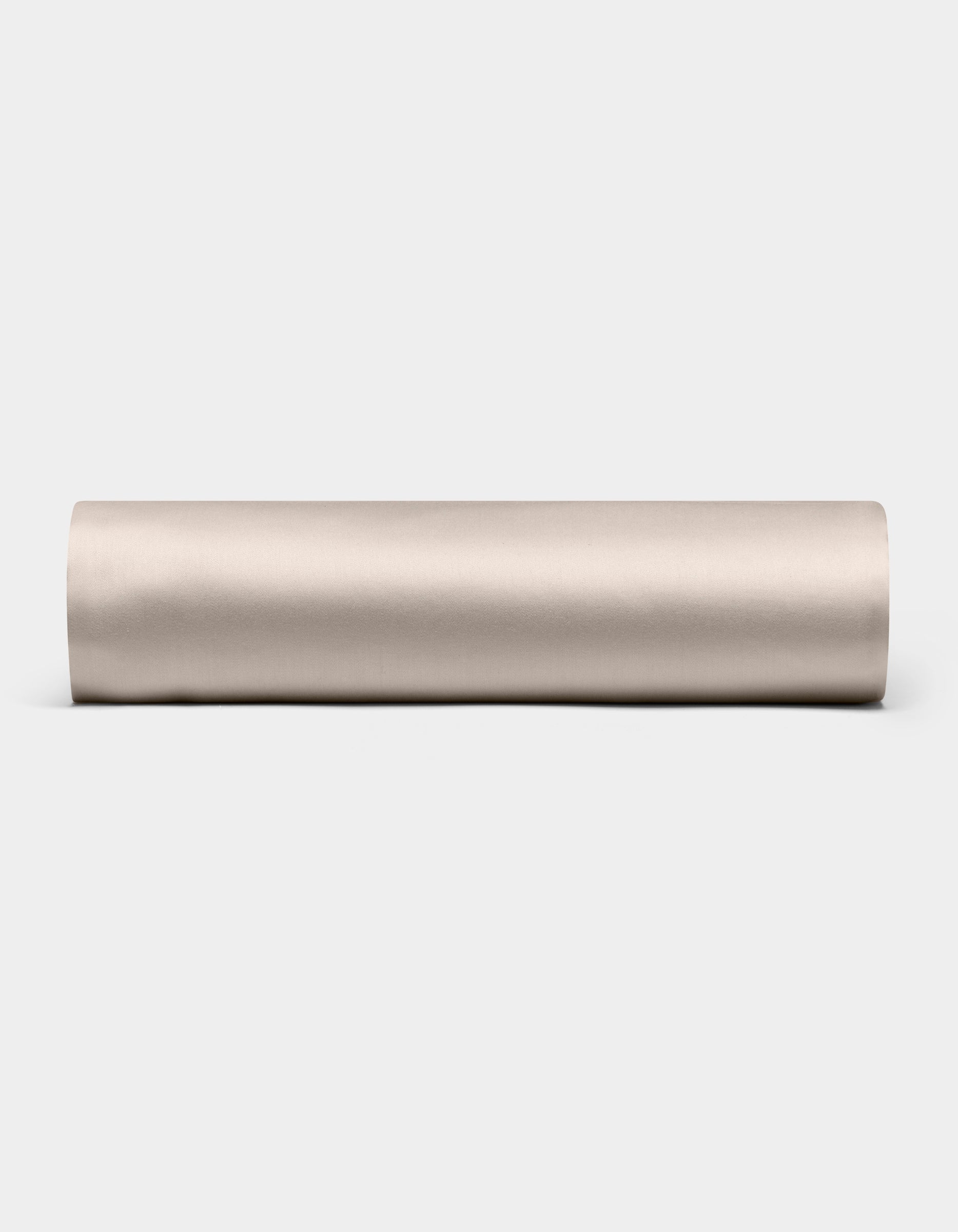 A Cozy Earth Bamboo Fitted Sheet in plain, light beige is shown lying horizontally on a white background, viewed from the side.|Color:Driftwood
