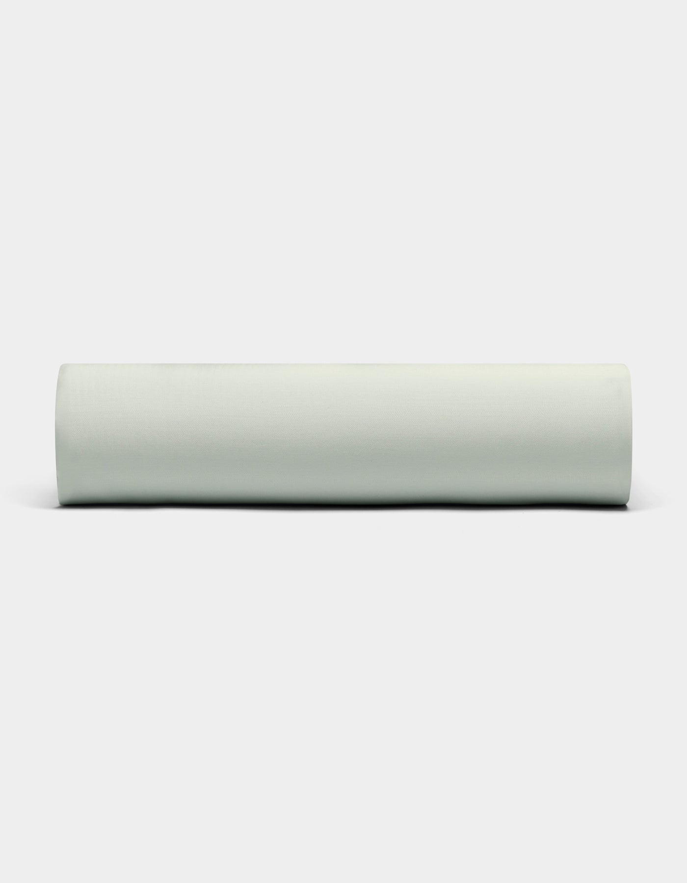 A Bamboo Fitted Sheet by Cozy Earth is displayed against a plain white background, viewed from the side. |Color:Laurel