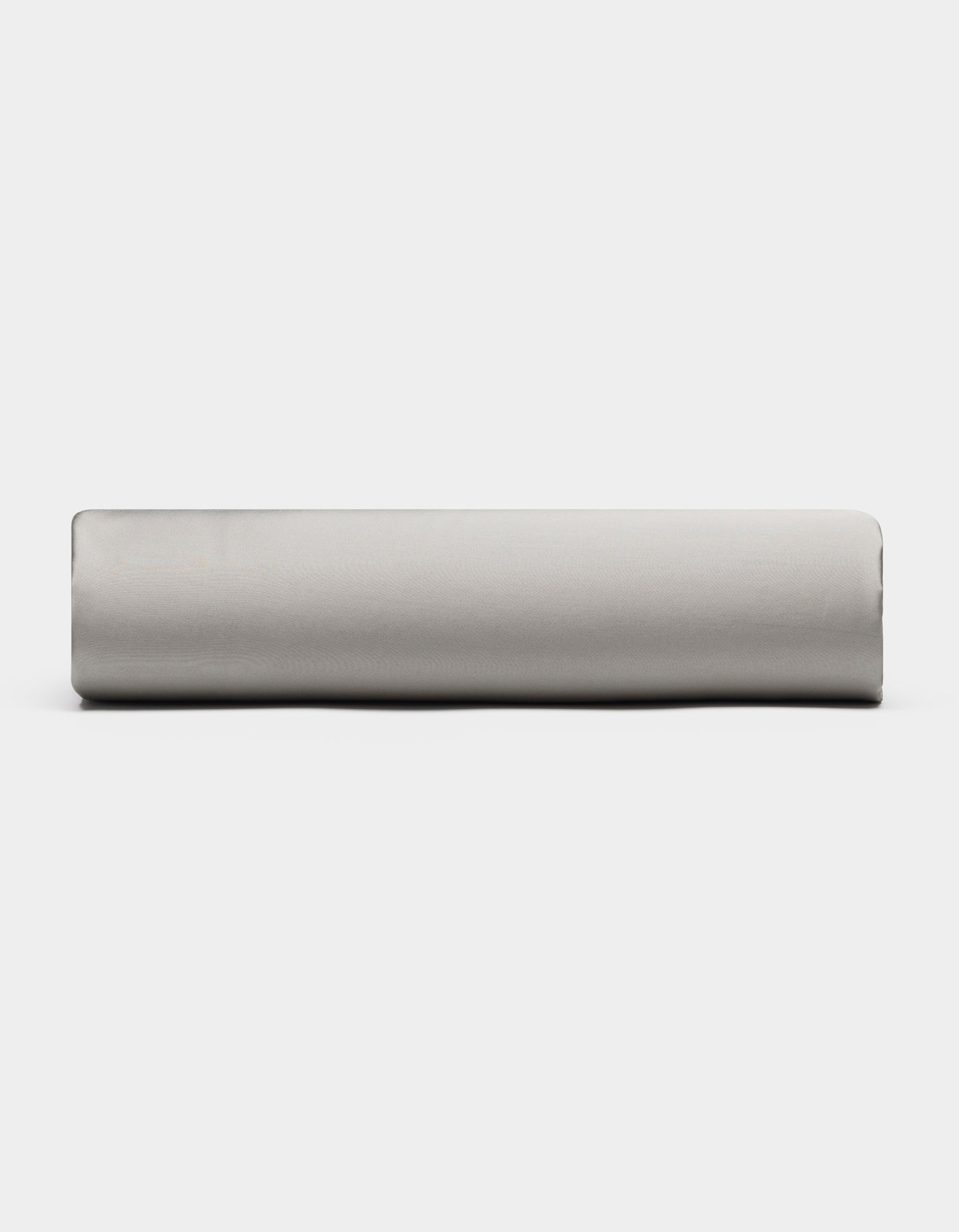 A Bamboo Fitted Sheet by Cozy Earth in light gray is displayed from the side against a plain white background.|Color:Light Grey