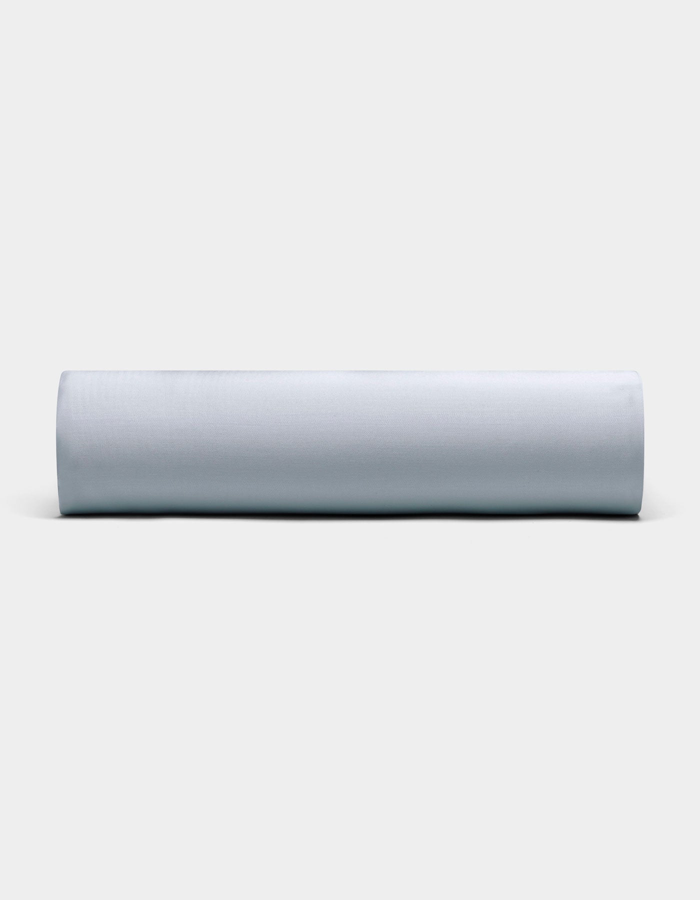 A Bamboo Fitted Sheet by Cozy Earth, neatly rolled and displayed horizontally, is showcased against a plain, light background with its soft light gray fabric visible from the front.|Color:Shore