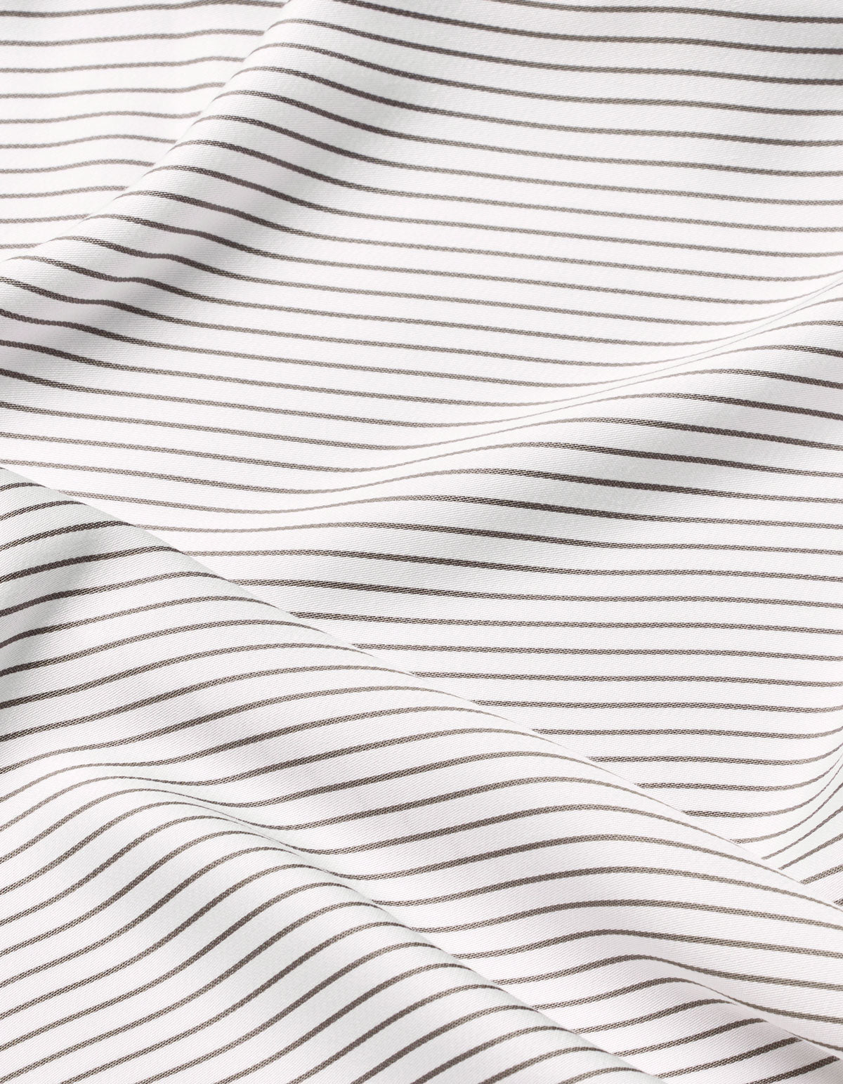 Close-up of Cozy Earth Bamboo Flat Sheet, featuring white fabric with thin, evenly spaced black horizontal stripes. The sheet is gently draped, creating soft folds and subtle shadows across its surface.
