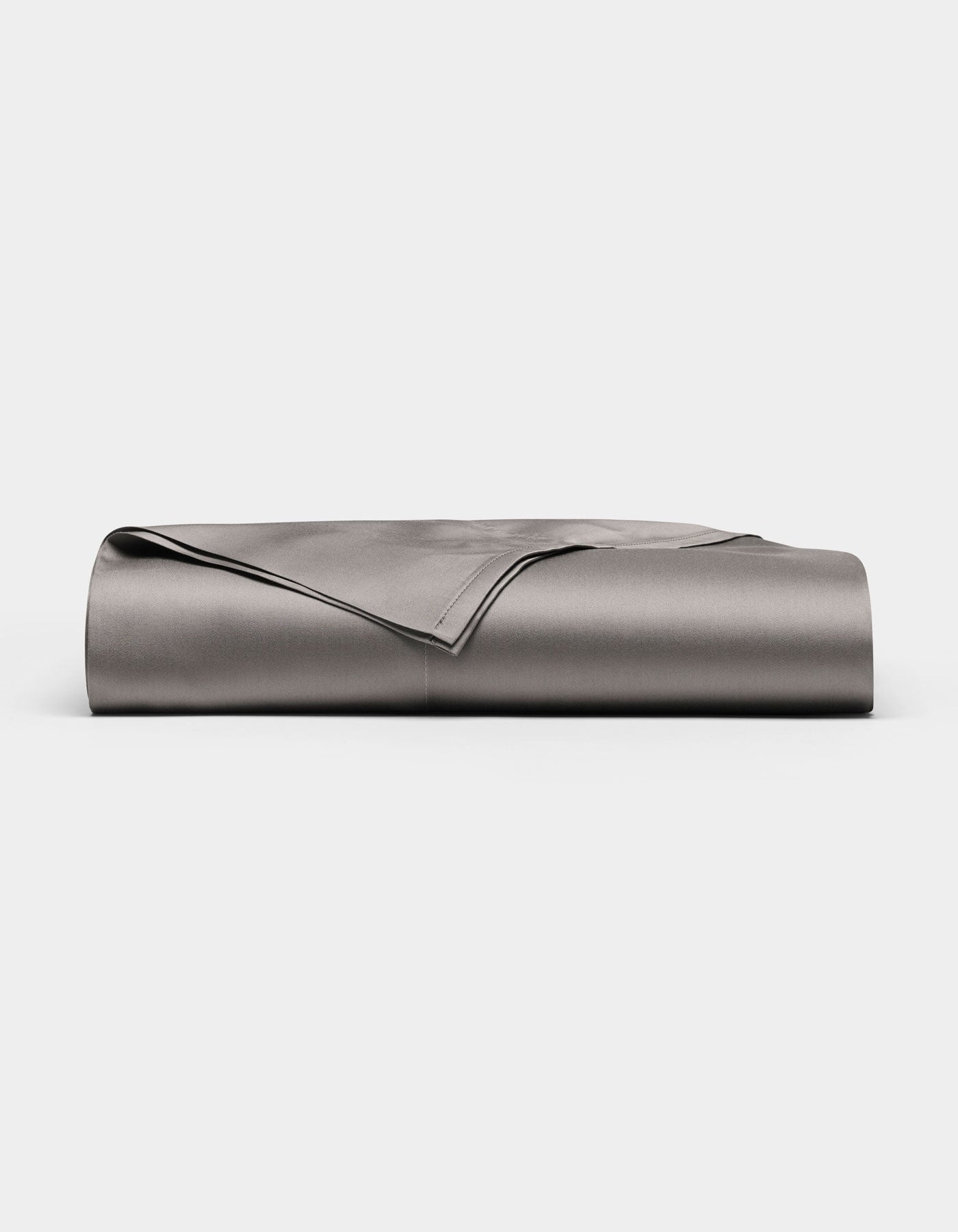 A neatly folded, smooth Cozy Earth Bamboo Flat Sheet in grey is displayed against a plain white background.|Color:Charcoal
