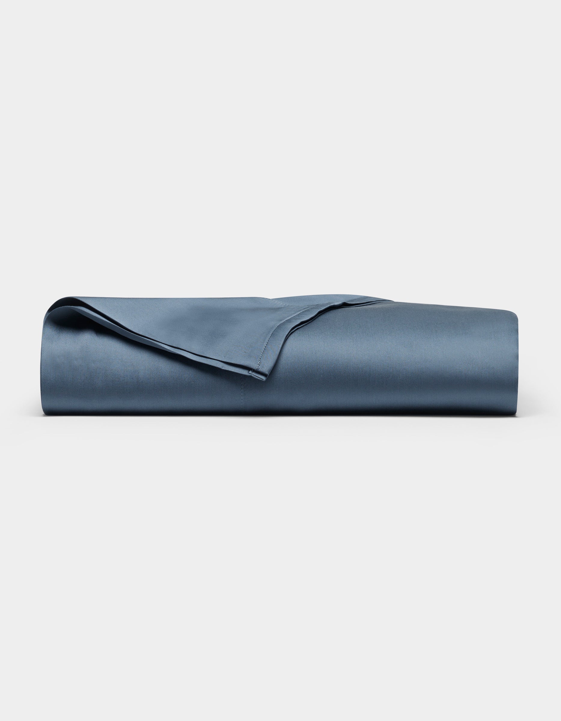 The Cozy Earth Bamboo Flat Sheet, neatly folded and smooth in navy blue, is displayed against a plain white background.|Color:Pacific Blue