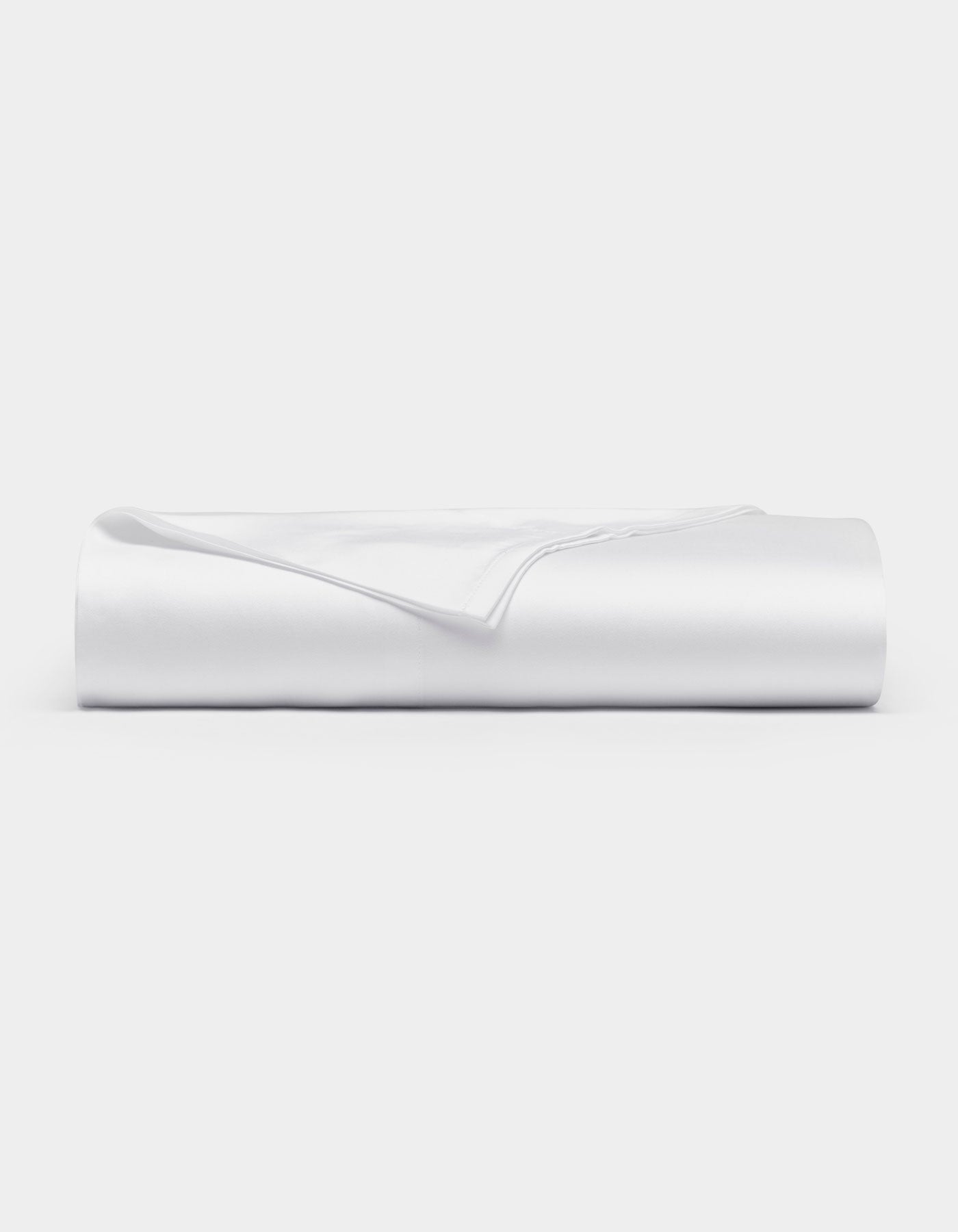 A neatly folded Cozy Earth Bamboo Flat Sheet in white rests on a flat surface against a plain white background.|Color:White