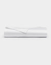 A neatly folded Cozy Earth Bamboo Flat Sheet in white rests on a flat surface against a plain white background.|Color:White
