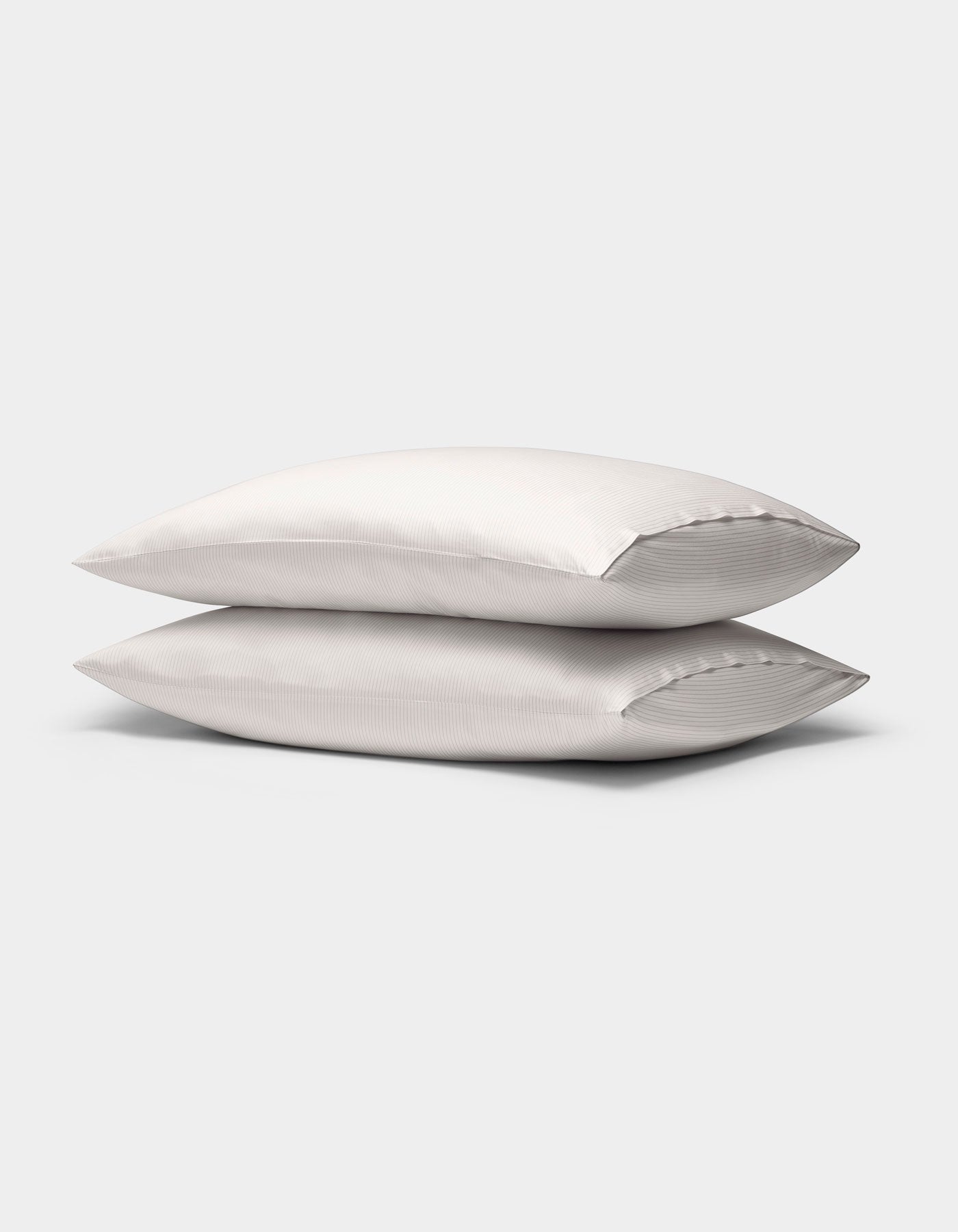 Two Cozy Earth Bamboo Pillowcases with subtle stripes are stacked together against a plain light gray background.
