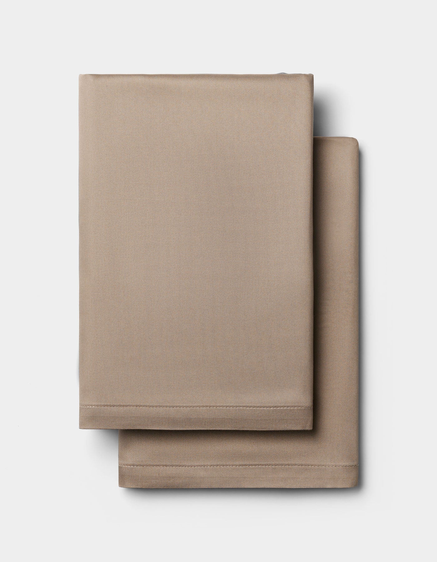 Two neatly folded Cozy Earth Bamboo Pillowcases are stacked on a plain white background.|Color:Walnut