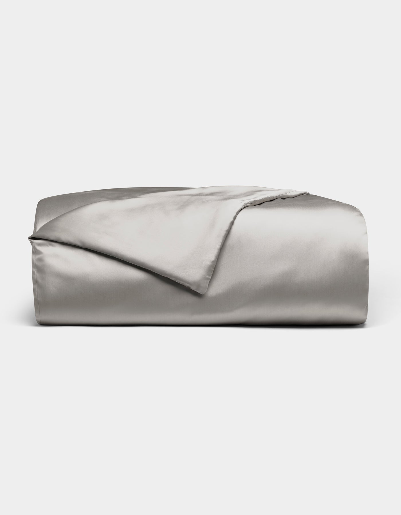 A neatly folded Cozy Earth Bamboo Duvet Cover in light gray is displayed against a white background, with one corner turned back to reveal its smooth, shiny fabric.|Color:Light Grey