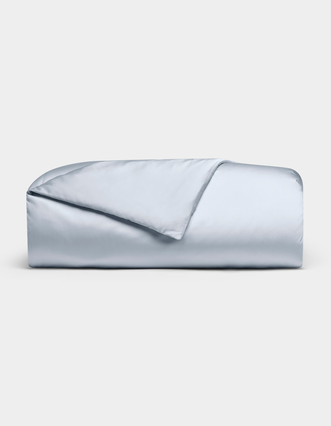 The Cozy Earth Bamboo Duvet Cover in light blue is neatly folded against a white background, with one corner flipped to reveal its smooth, silky texture.|Color:Shore