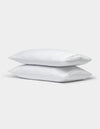 Two Cozy Earth Bamboo Pillowcases in white are stacked together against a plain light gray background.|Color:White