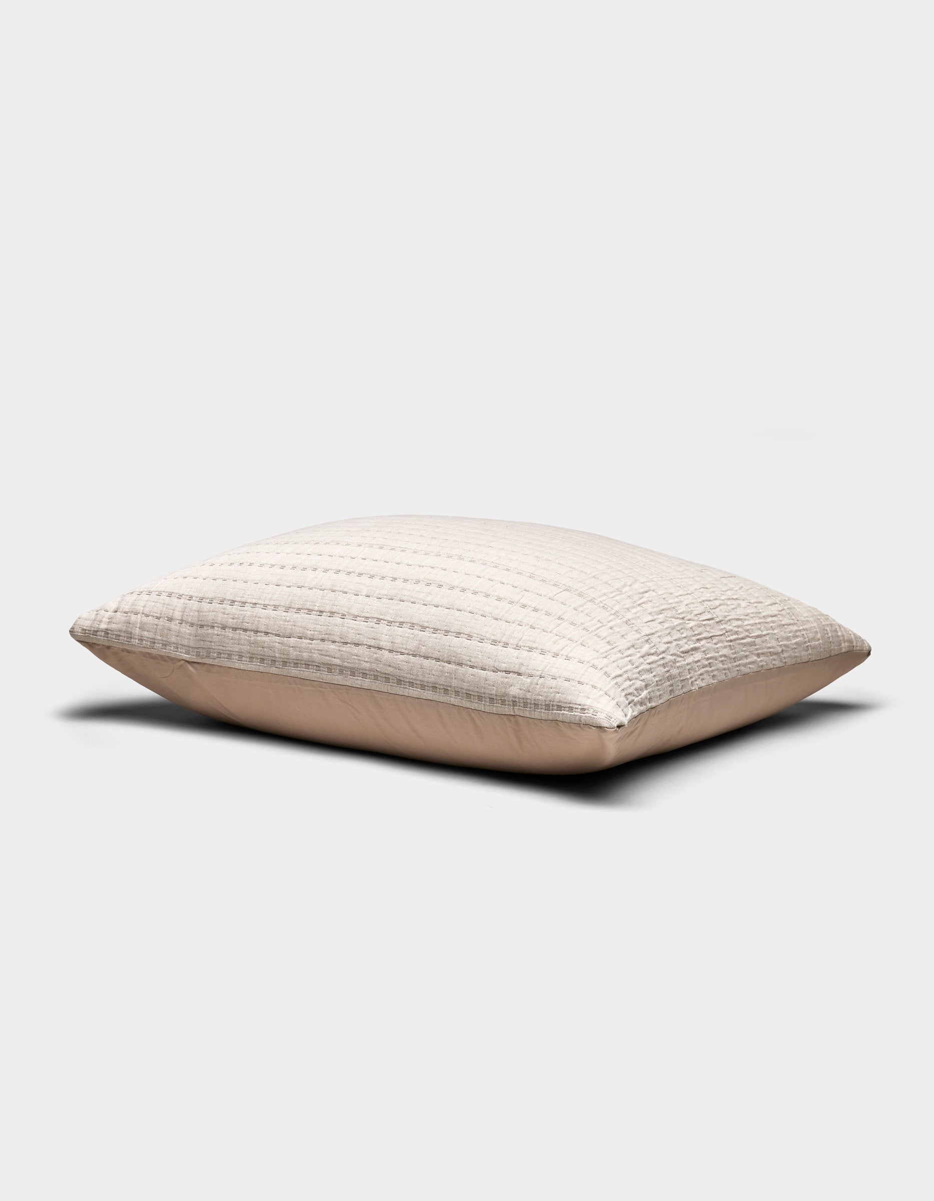The Baja Matelasse Sham by Cozy Earth is a beige, rectangular pillow sham featuring a textured, quilted design, shown on a plain white background.|Color:Ebony/Taupe