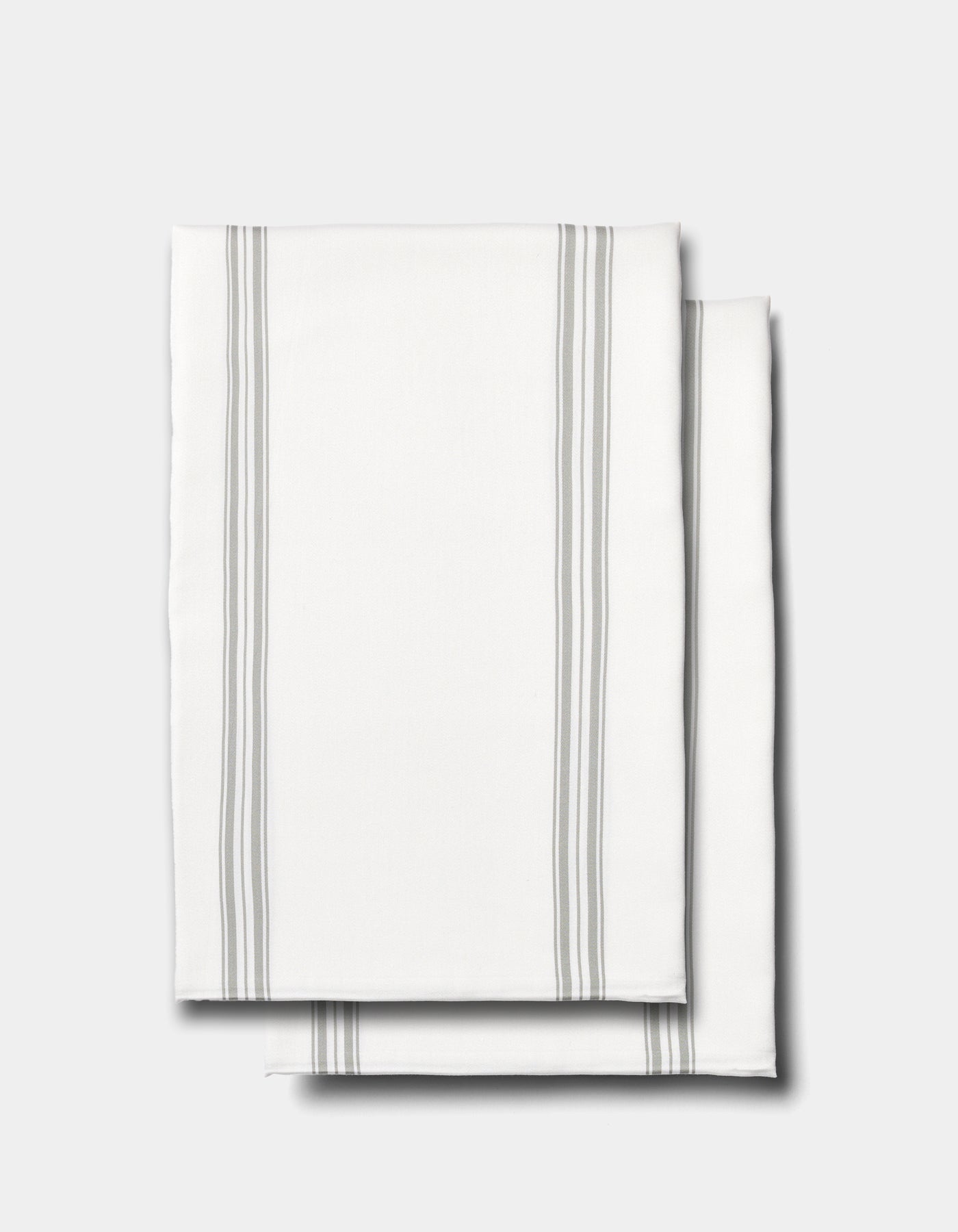 Two neatly folded Cozy Earth Bamboo Pillowcases in white, featuring thin gray vertical stripes along the edges, displayed on a plain light gray background.