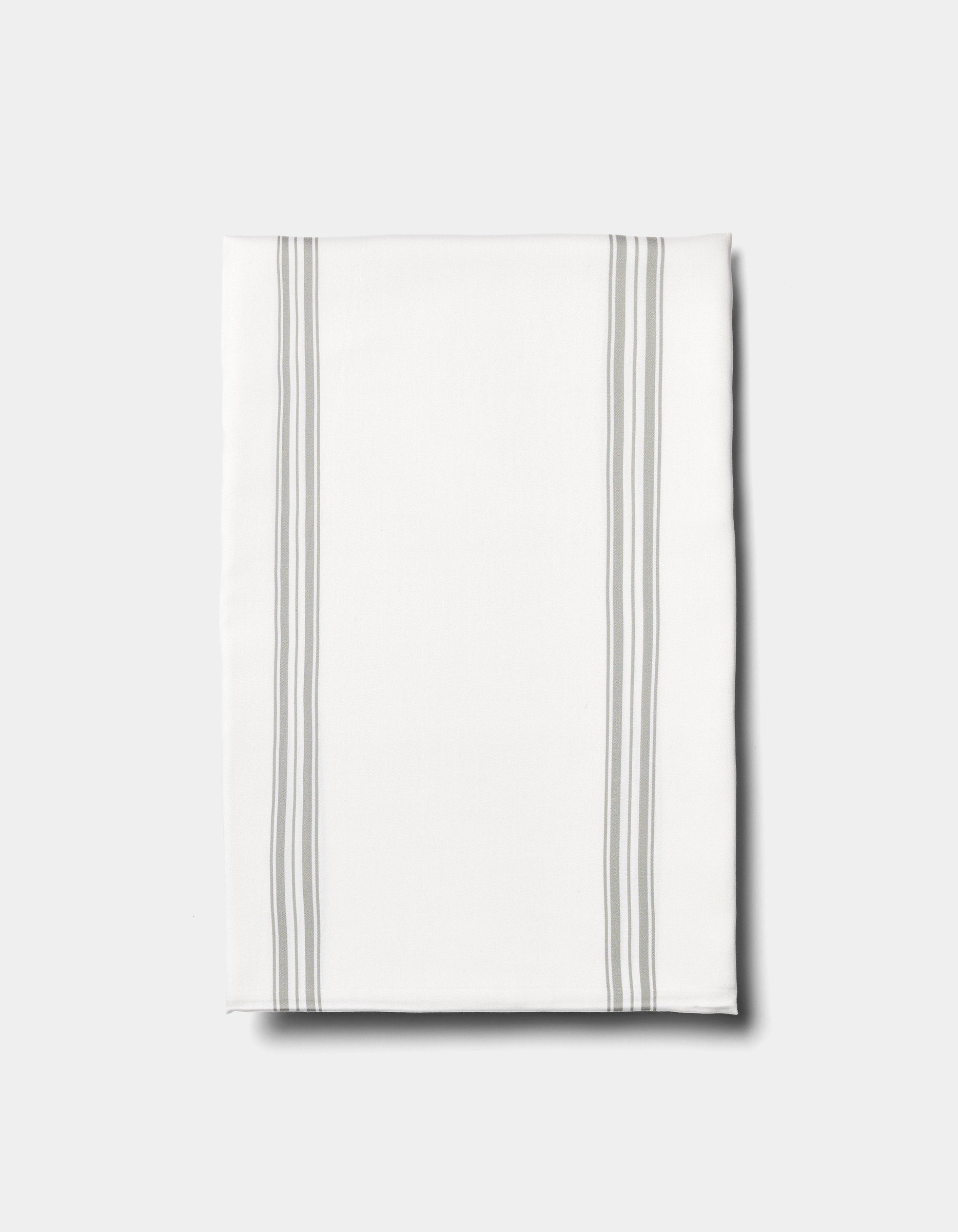 The Cozy Earth Bamboo Sheet Set is displayed on a plain light background, featuring neatly folded white fabric with two pairs of parallel light gray stripes running vertically near the edges.|Color:Baja Stripe in Laurel