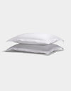 Two Cozy Earth Linen Shams with ruffled edges are stacked neatly against a plain light background.|Color:White