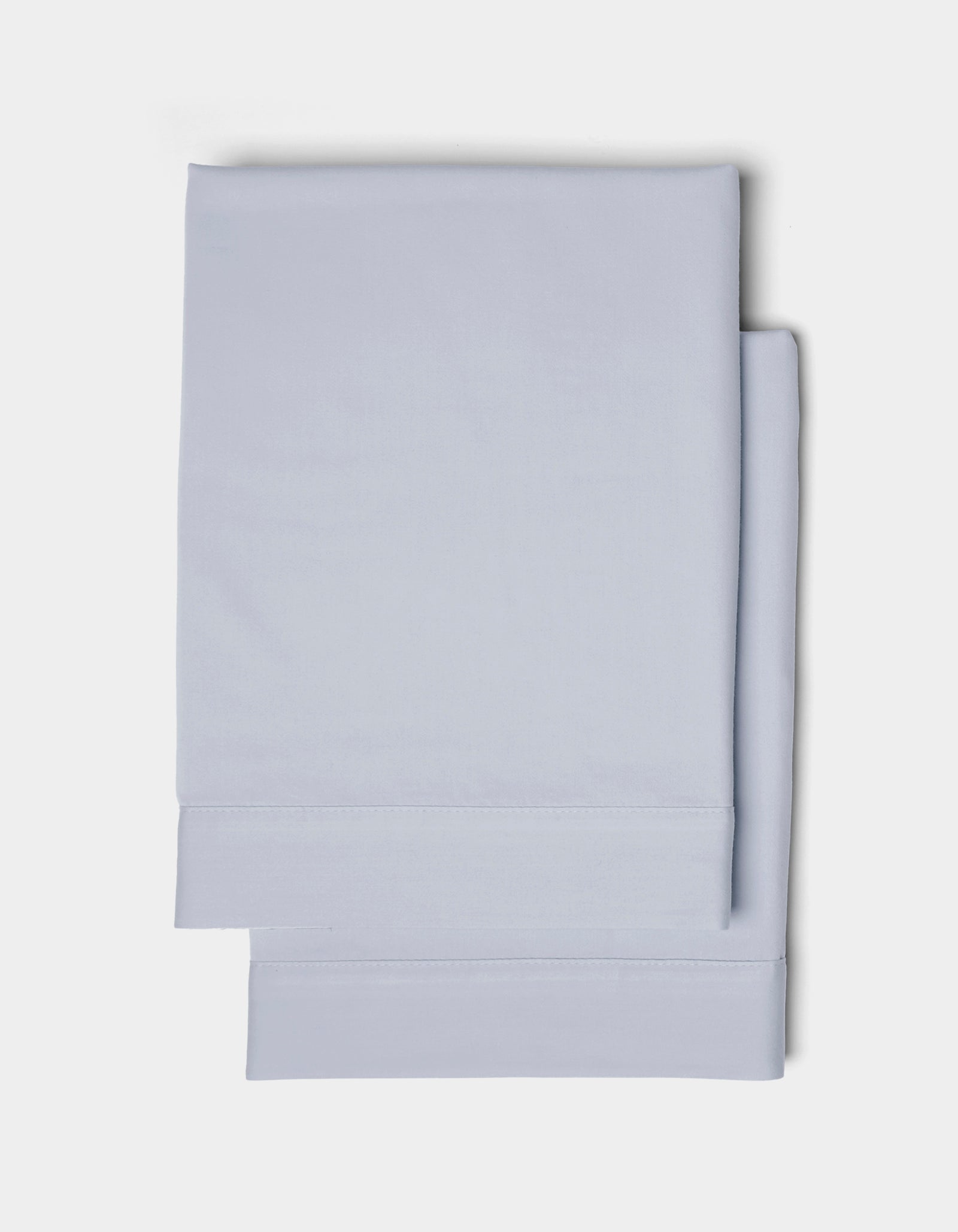Two neatly folded Cozy Earth Soft-Wash Cotton Shams in light blue are stacked together against a plain white background.