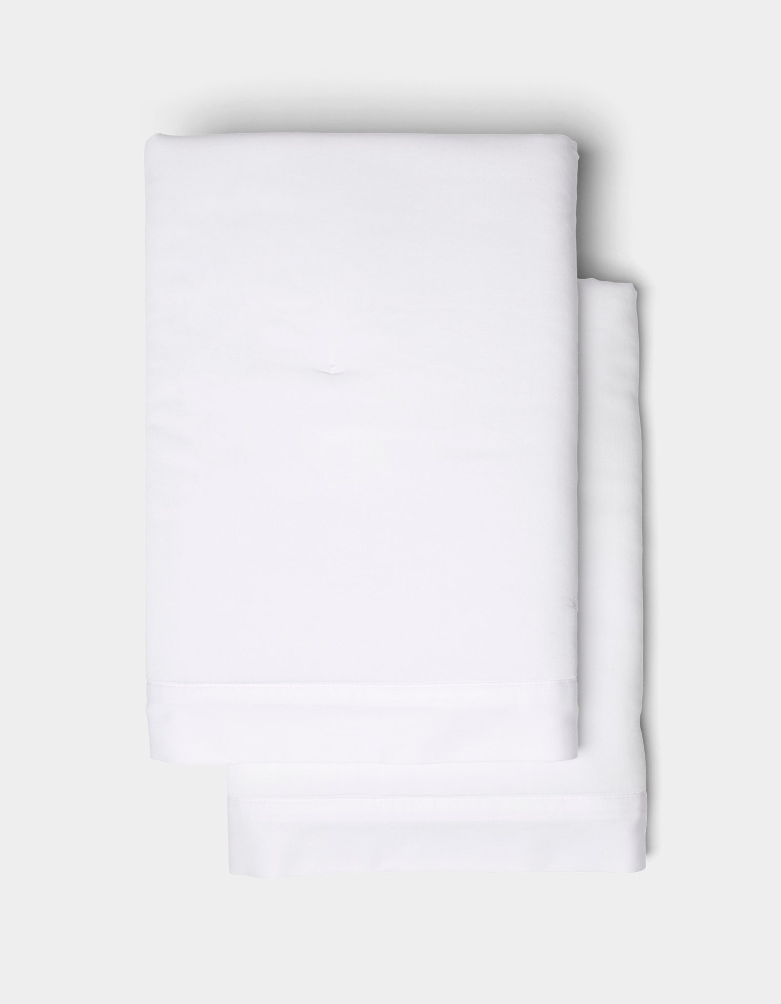 Two Soft-Wash Cotton Quilted Shams by Cozy Earth, neatly folded and stacked atop each other, set against a light gray background.