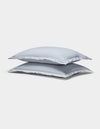 Two Cozy Earth Soft-Wash Cotton Shams in light gray are stacked neatly against a plain white background.|Color:Shore