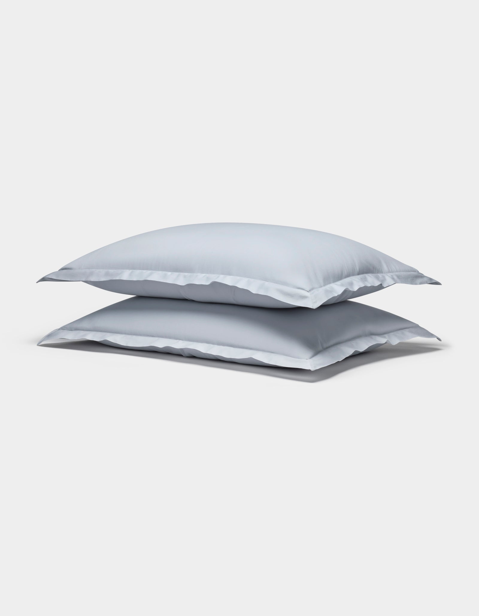 Two Cozy Earth Soft-Wash Cotton Shams in light gray are stacked neatly against a plain white background.