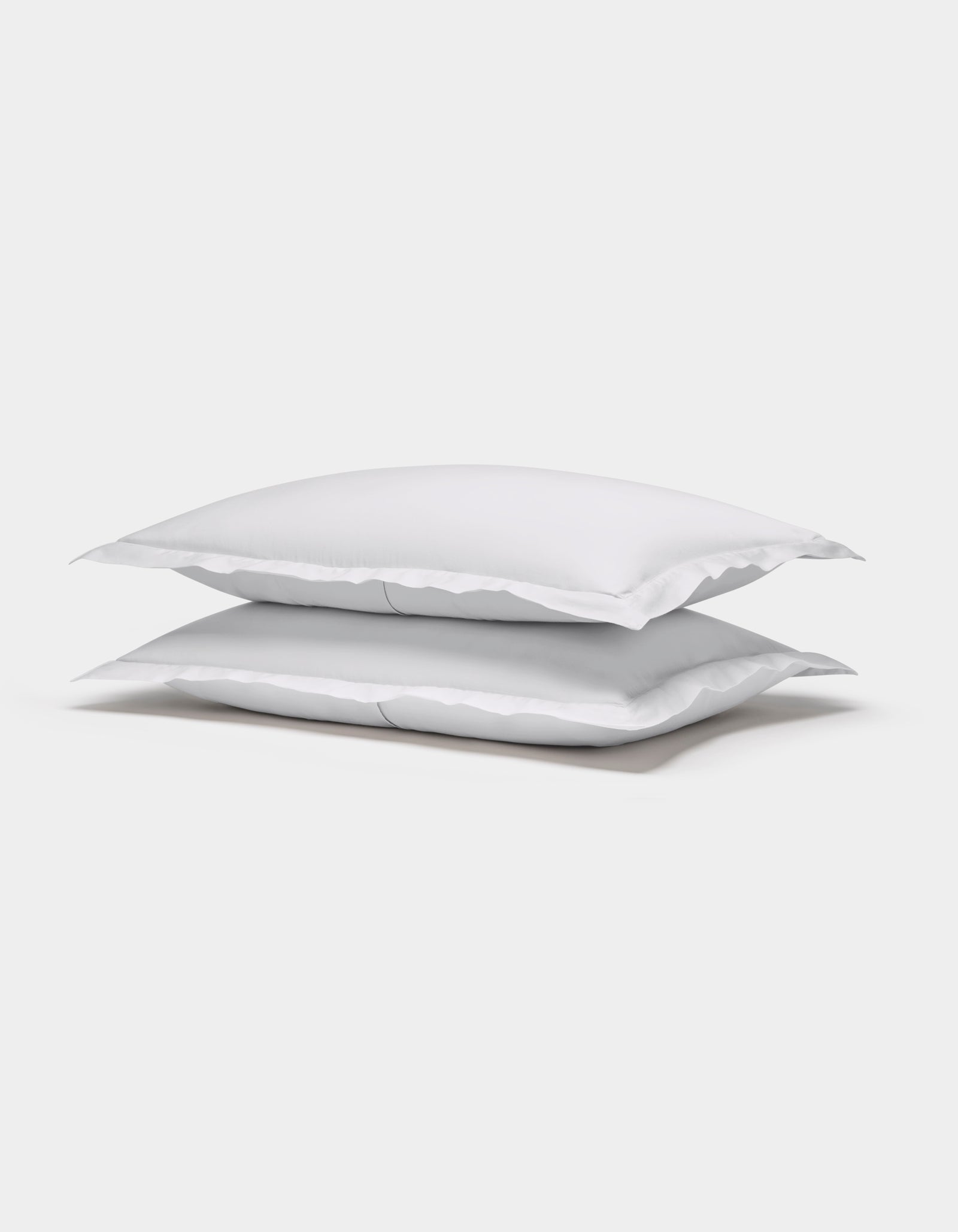 Two Cozy Earth Soft-Wash Cotton Shams are stacked neatly on top of each other against a plain white background.