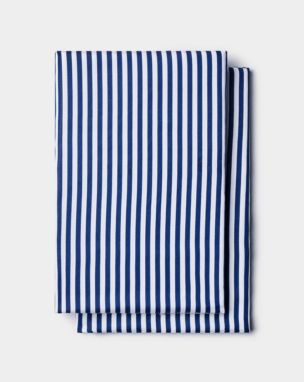 Cozy Earth Bamboo Pillowcases featuring neatly folded fabric with vertical blue and white stripes, displayed on a light gray background.|Color:Classic Stripe in Pacific