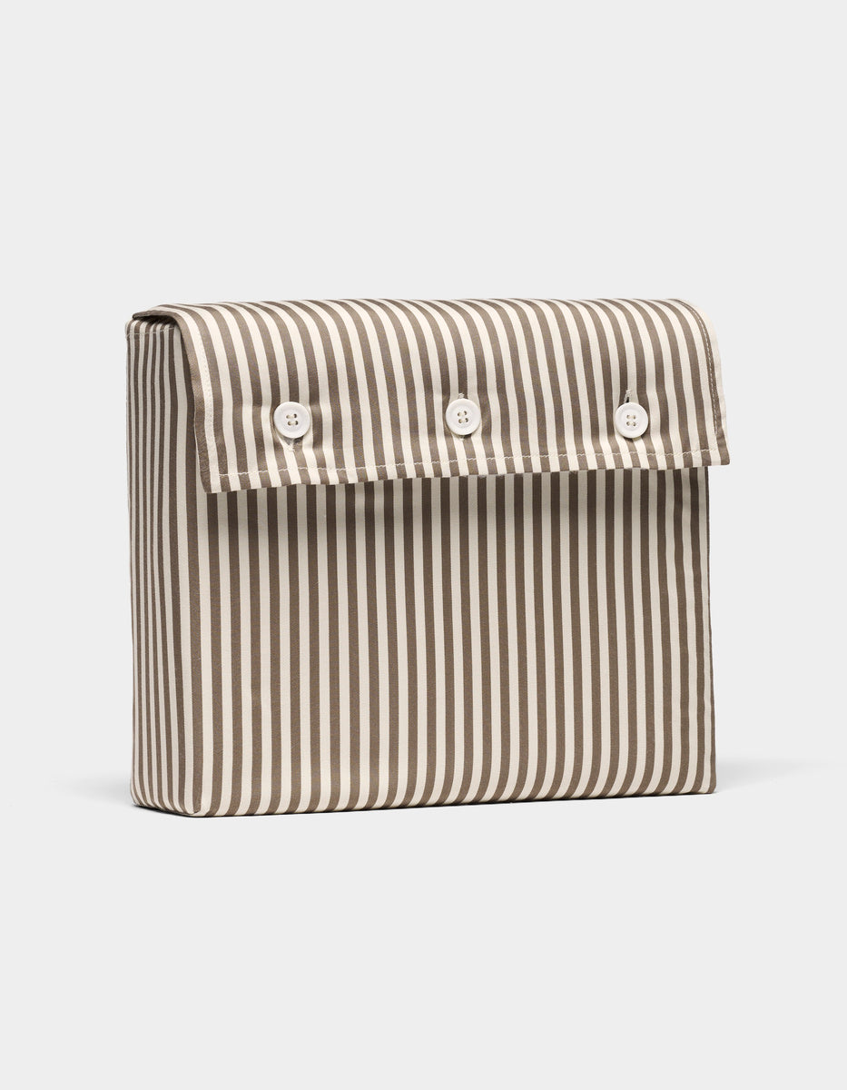 The Bamboo Sheet Set by Cozy Earth comes in a rectangular pouch with vertical blue and white stripes and a front flap secured by three white buttons.|Color:Classic Stripe in Ebony
