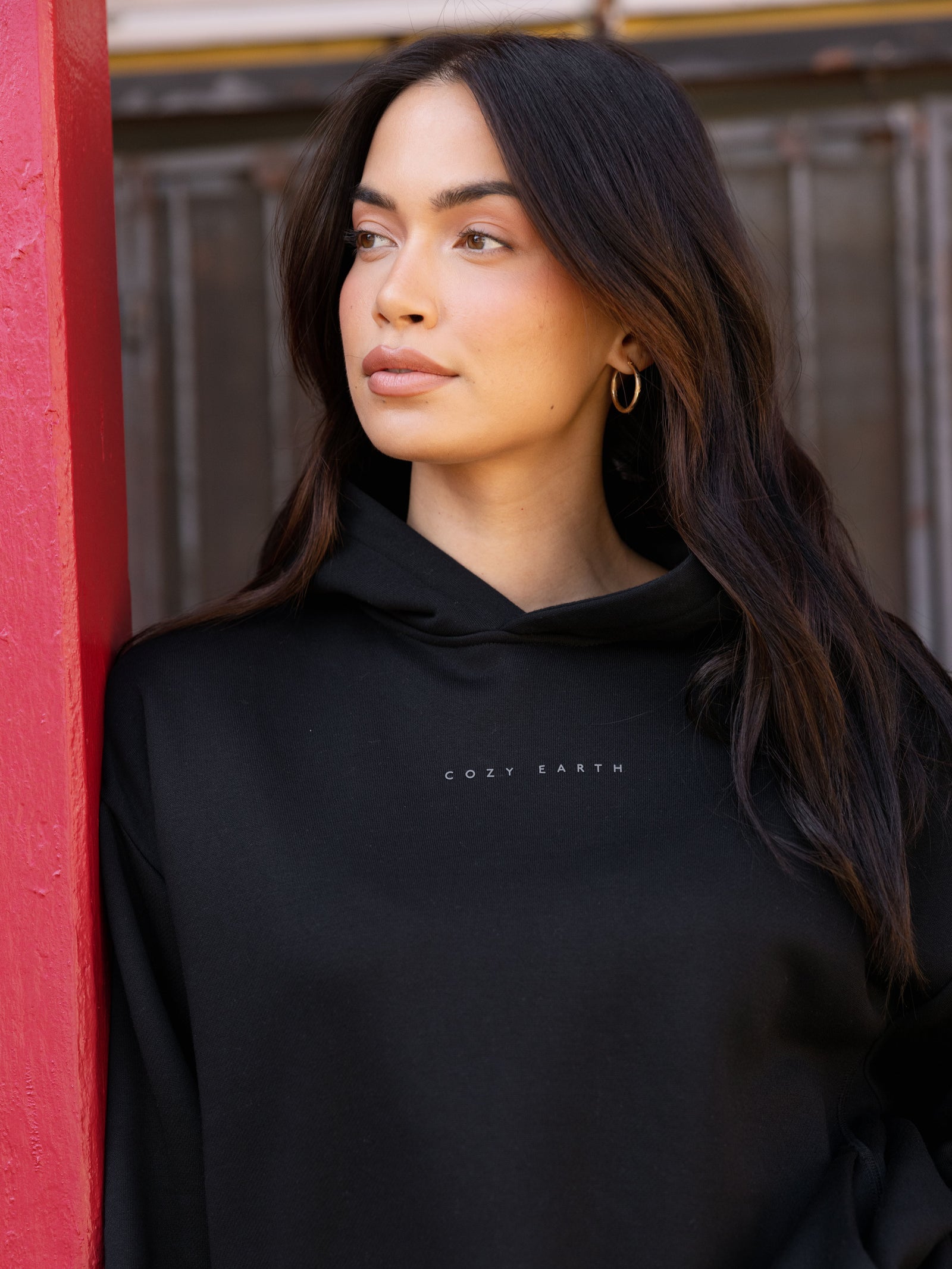 Close up of woman wearing black cityscape hoodie 