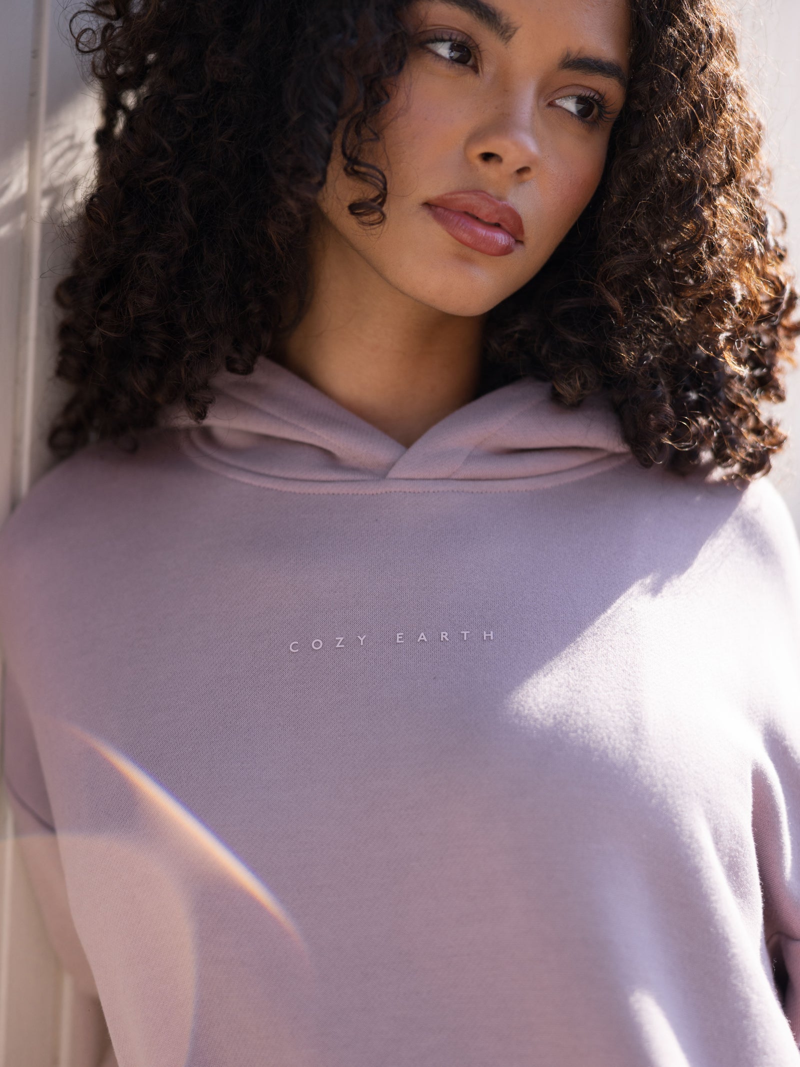 Close up of woman wearing dusty orchid cityscape hoodie 
