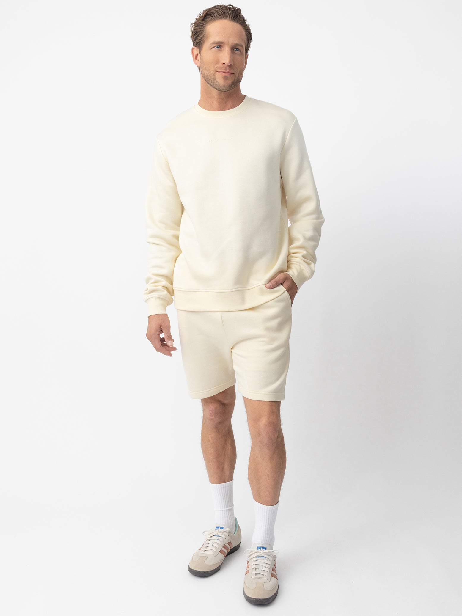 Man wearing Alabaster CityScape Shorts with white background