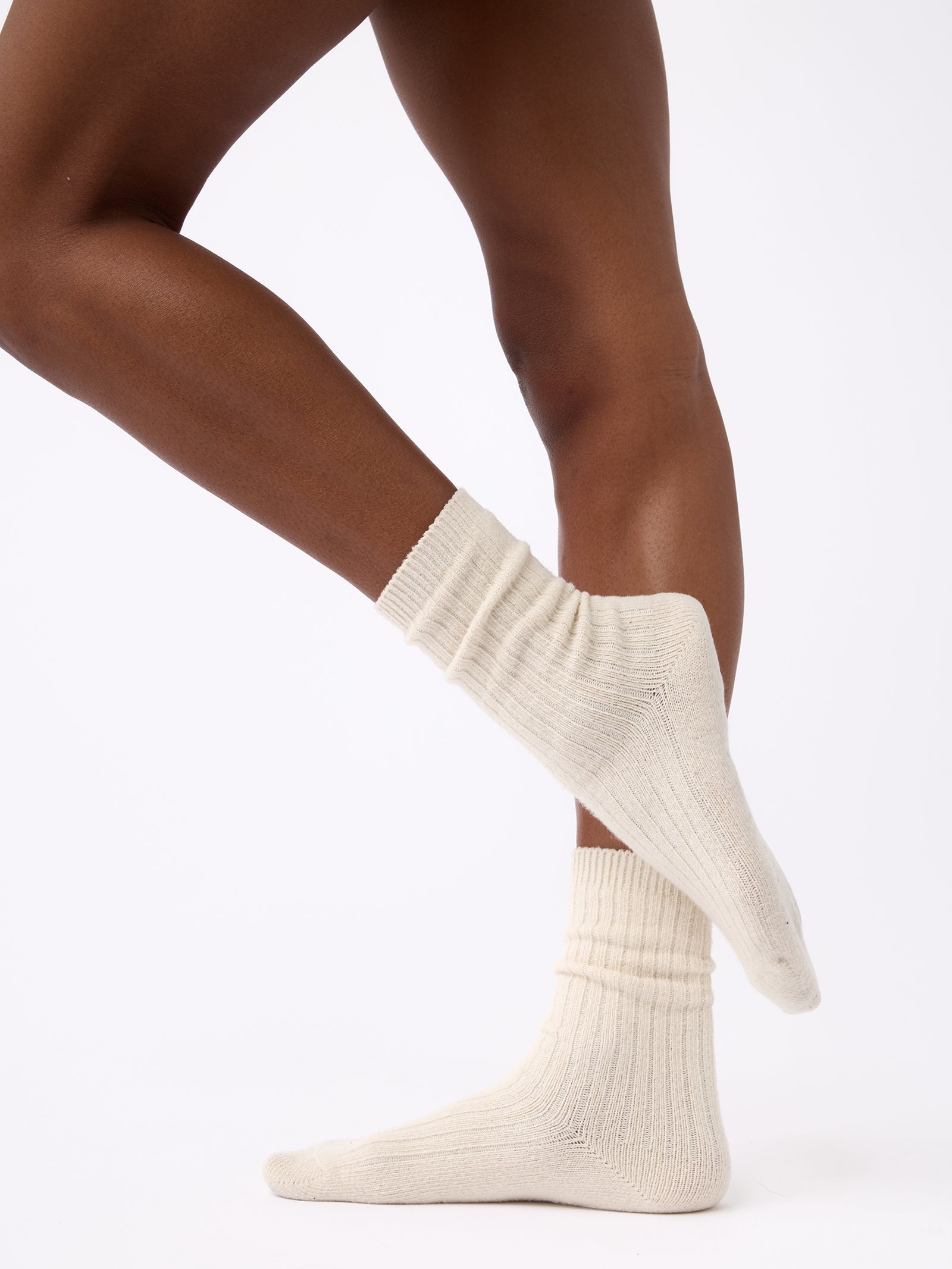 Person wearing Cozy Earth Plush Lounge Sock 1-Pack in Alabaster
