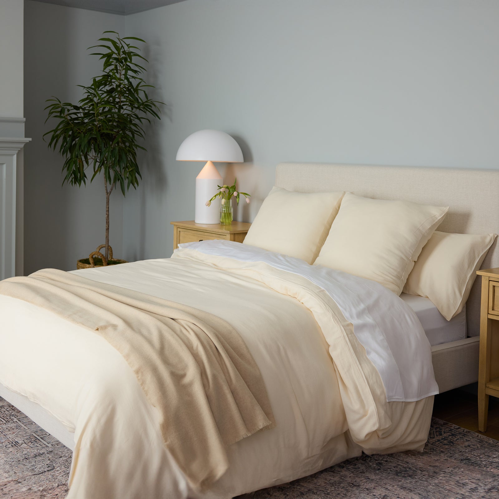 Buttermilk Aire Bamboo Duvet Cover. The Duvet Cover has been photographed while on a bed in a home bedroom.