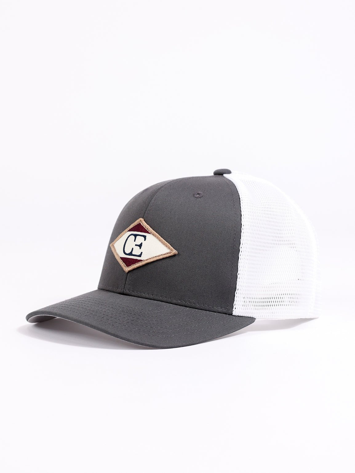 Studio shot of charcoal/white diamond mesh trucker hat showing the side