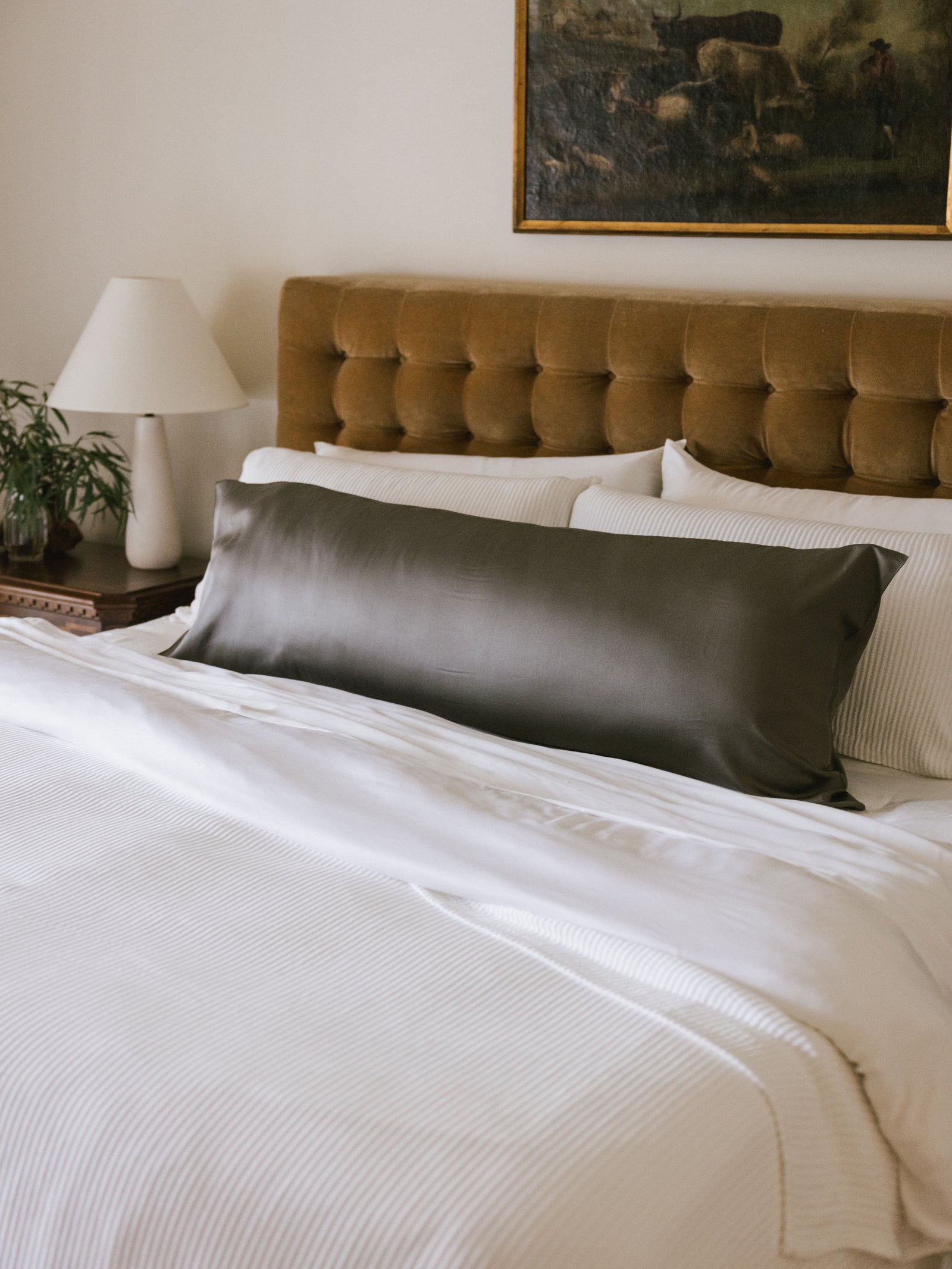 Body pillow with charcoal case on bed