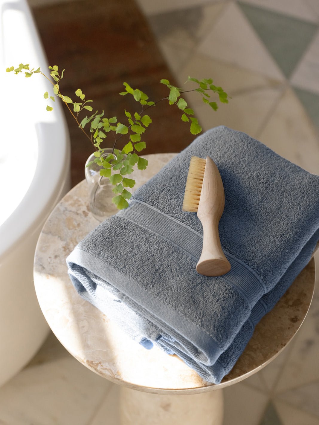 Harbor mist hand towels on small table with brush 
